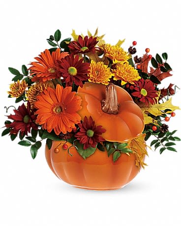 Country Pumpkin - This pumpkin is sure to please! Send your special someone fall flowers and a keepsake gift with this reusable ceramic pumpkin arrangement. The fun Halloween decoration or spirited fall floral decoration for the home or office can later be used to serve Thanksgiving soup or stuffing!         •Orange gerberas, bronze cushion mums, red daisies, huckleberry and salal are accented with yellow oak leaves and artificial fall berries. •Presented in a reusable ceramic pumpkin container. •Orientation: One-Sided 