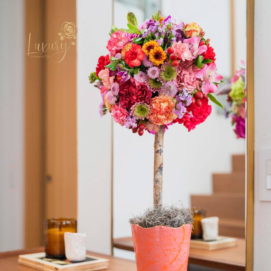 Topiary Charlize Topiary Charlize - "PLACE YOUR ORDER AT LEAST 2 DAYS PRIOR TO THE DELIVERY DATE” These flower trees will make anyone fall in love. Each one is unique. All Occasions. Size: 6" in diameter of the topiary. Ceramic Pot. Check our coverage area. Occasionally, flowers and/or container substitutions occur due to weather, seasonality, and market conditions, which may affect availability. If this is the case with the gift you’ve selected, we will ensure that the style, theme, and color scheme of your arrangement are preserved and will only substitute items of equal value or higher value