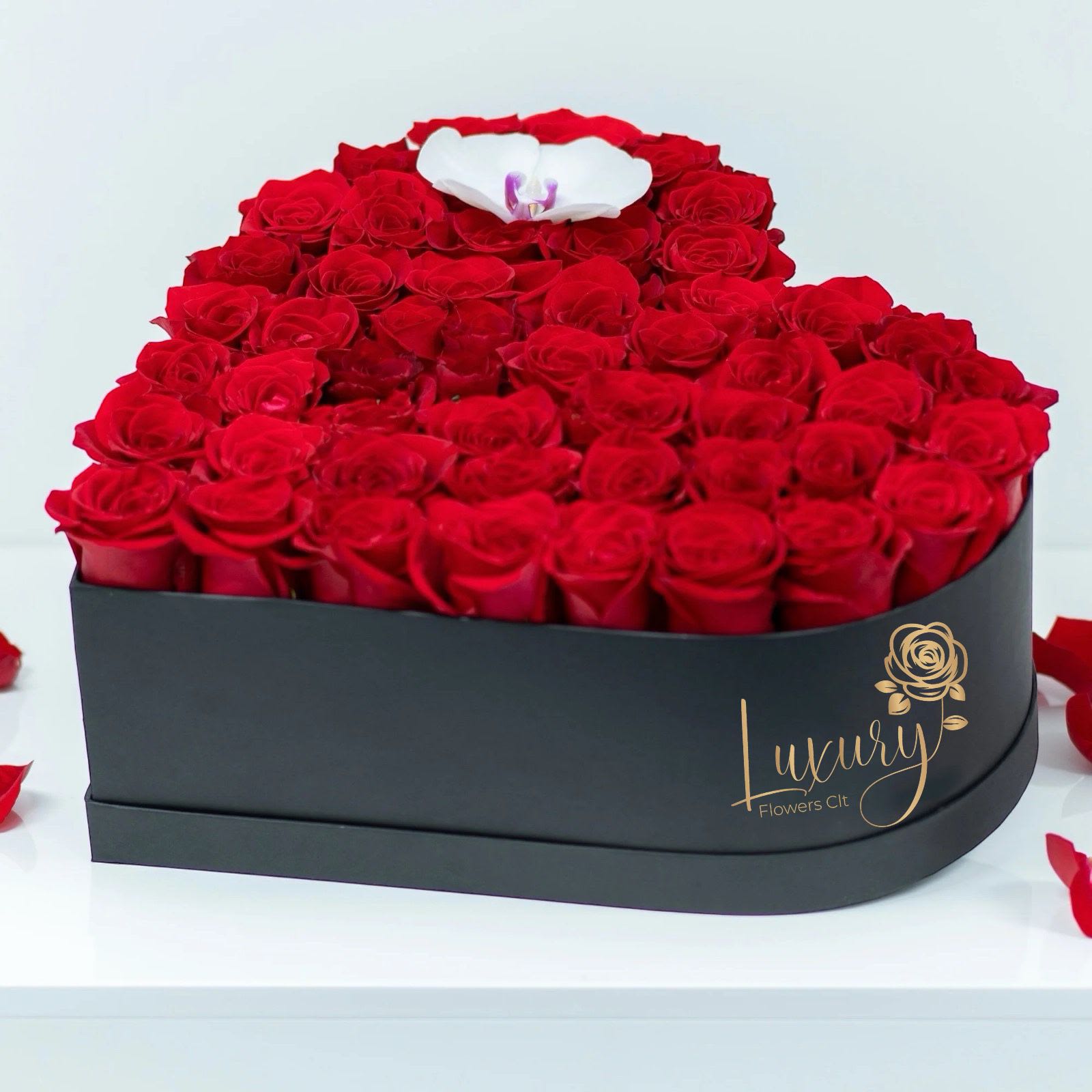 Feel the Love  - These fancy heart boxes make it perfect to show how much you love that special one in your life. Feel the Love!  Roses in Box: 36-40 stems of natural roses and one stem orquid Color Box: White or Black (subject to inventory availability)   Place your Order Online Monday to Saturday before 1:00 p.m. (E.T.) for same-day delivery.   “Orders received after hours will be delivered the next business day”. Check our coverage area. Occasionally, substitutions of flowers and/or containers happen due to weather, seasonality, and market conditions which may affect availability. If this is the case with the gift you’ve selected, we will ensure that the style, theme, and color scheme of your arrangement are preserved and will only substitute items of equal value or higher value.  CARE INSTRUCTIONS Gently mist the arrangement with natural water every other day. Do not spray any cleaning product on the flower arrangement. Do not place heavy objects directly on the flower arrangement. Keep them out of direct sunlight and extreme heat. 