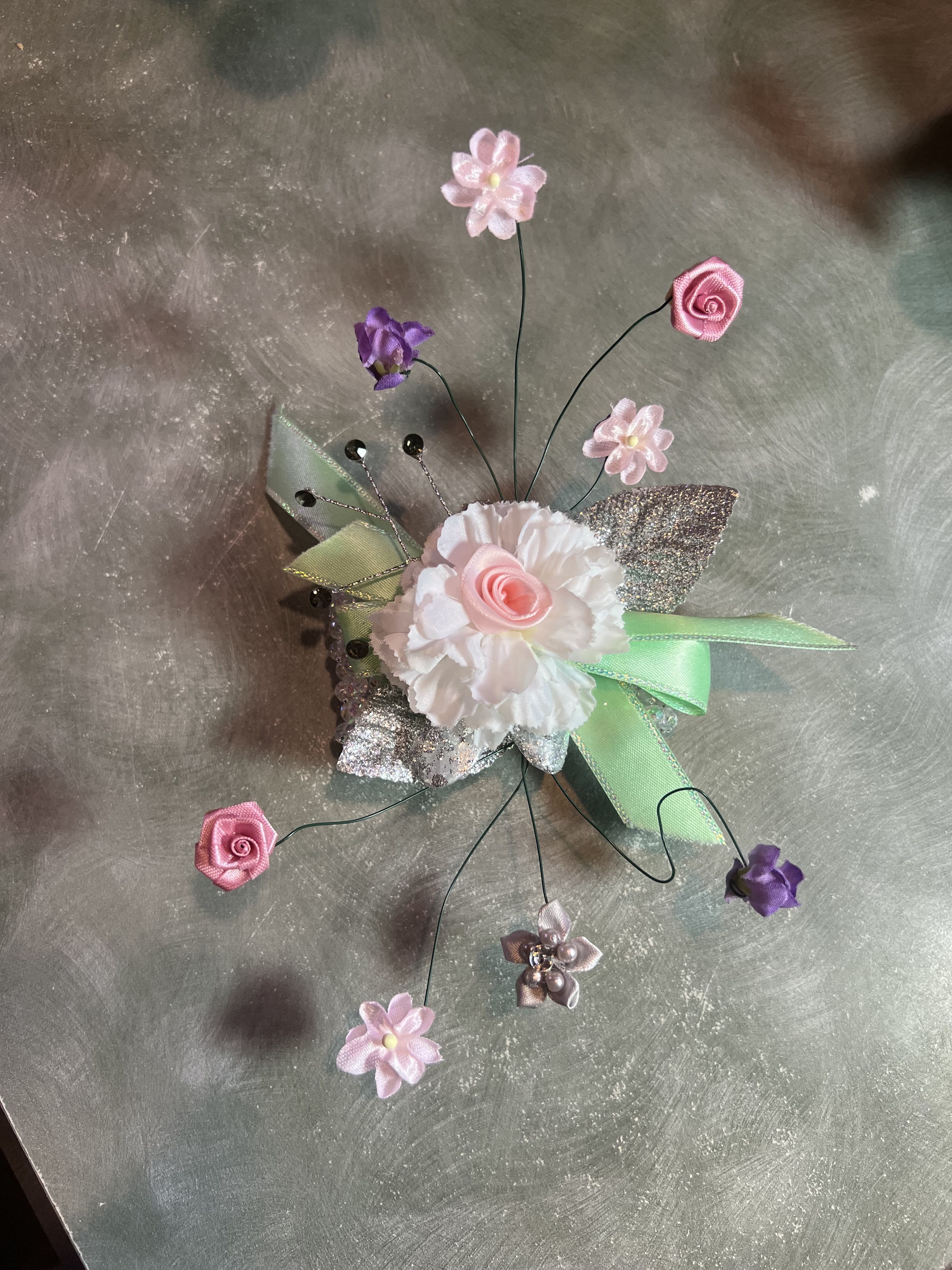 Flowers floating on Air - Our NEWEST creation takes a little time, so pre-order only, as this design takes two days to make. Our example is created with silk flowers, but real fresh flowers can be used. Do let us know the colors of flowers needed and we will let you know if they can be stringed on a wire. ( not all flowers work on a wire form.) 