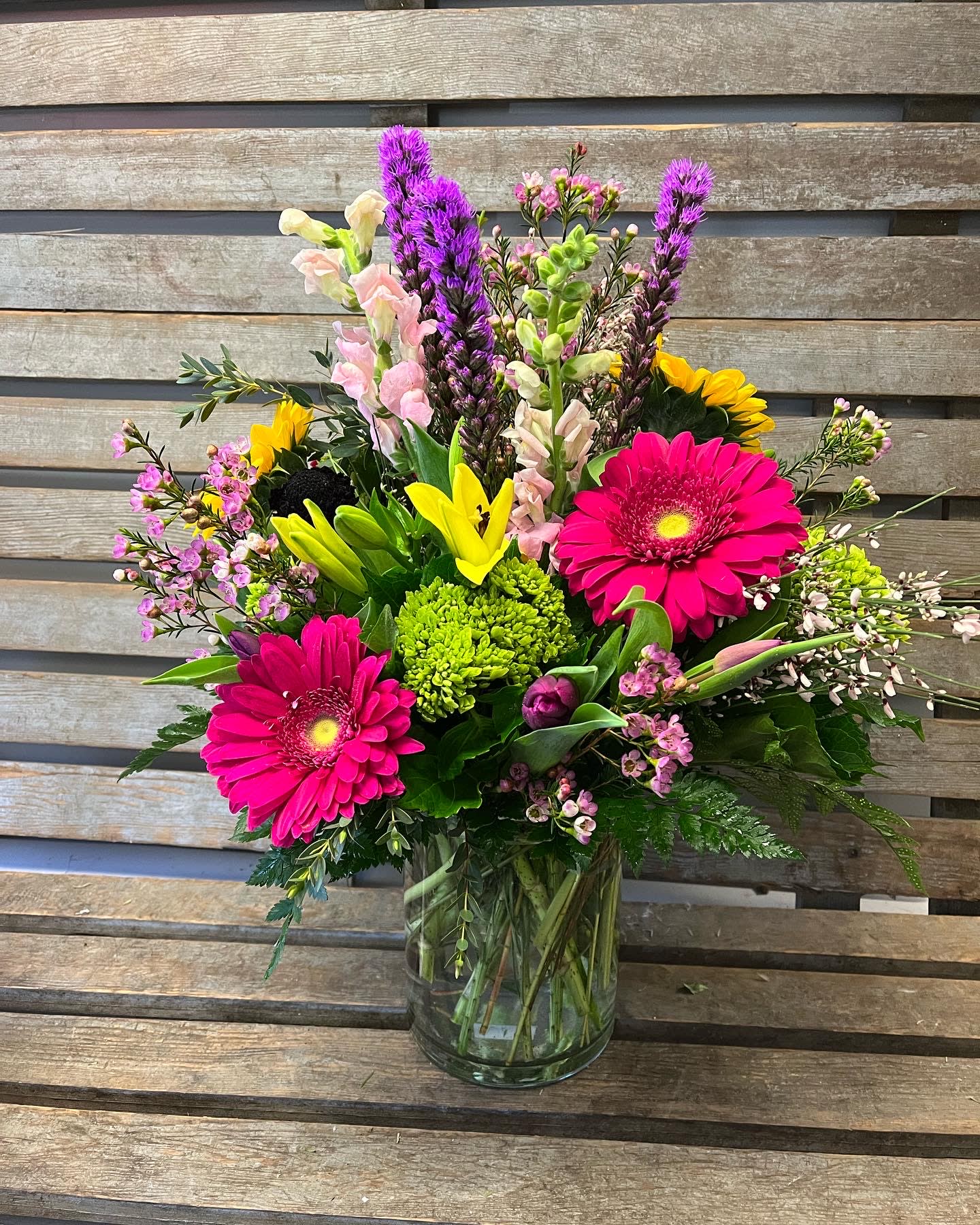 Designer’s Choice  Wow!  - Large cylinder vase filled with our designer’s choice of the freshest flowers that day. Sure to WOW!  Not a fall of Fall colors, no problem .This is a bright mix!