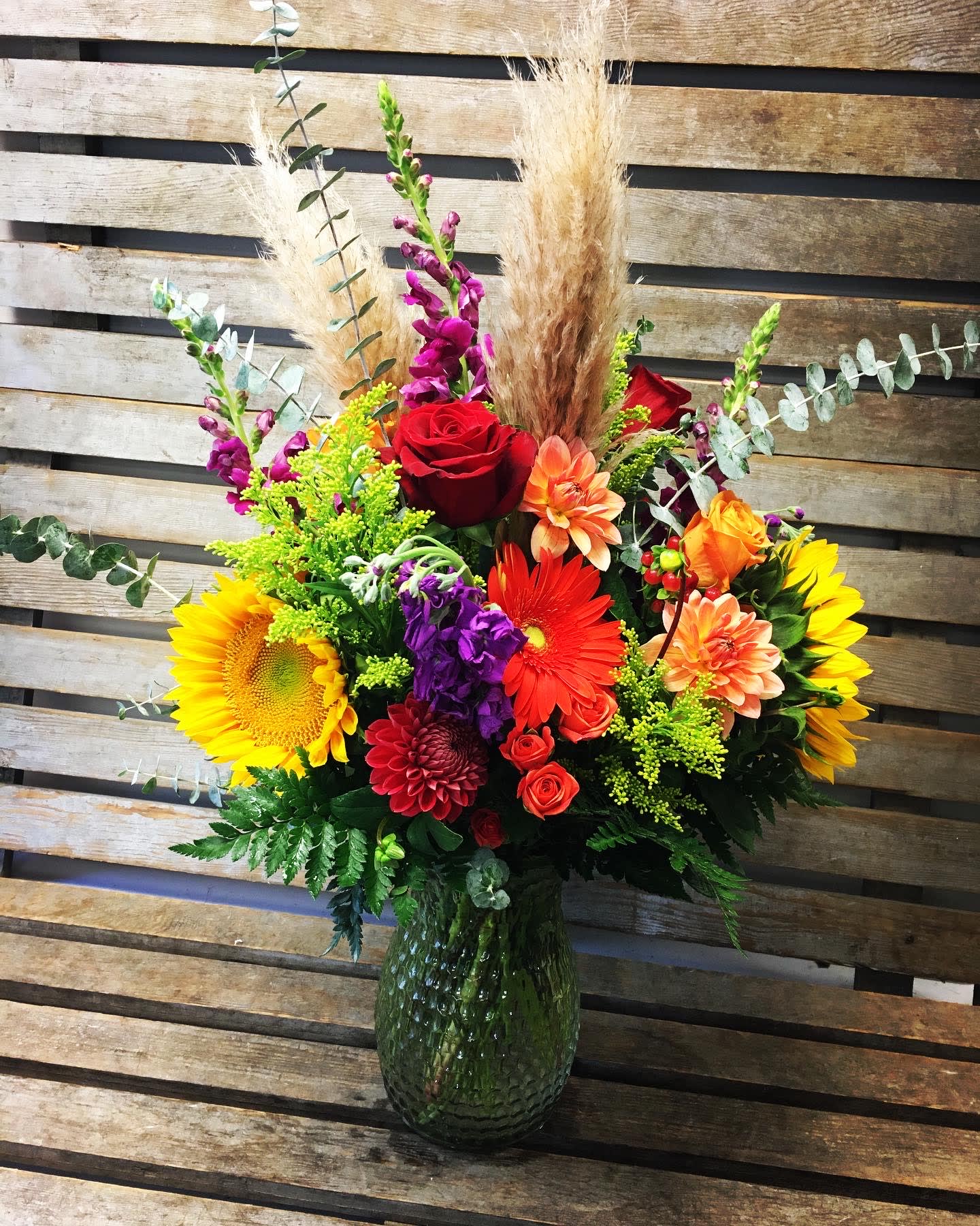 Large designers choice Seasonal  Vase ( VASE STYLE MAY VARY) - Designers choice of the freshest seasonal flowers in a large vase. Accented with different textures of greens and pampas grass. Colors will reflect the season