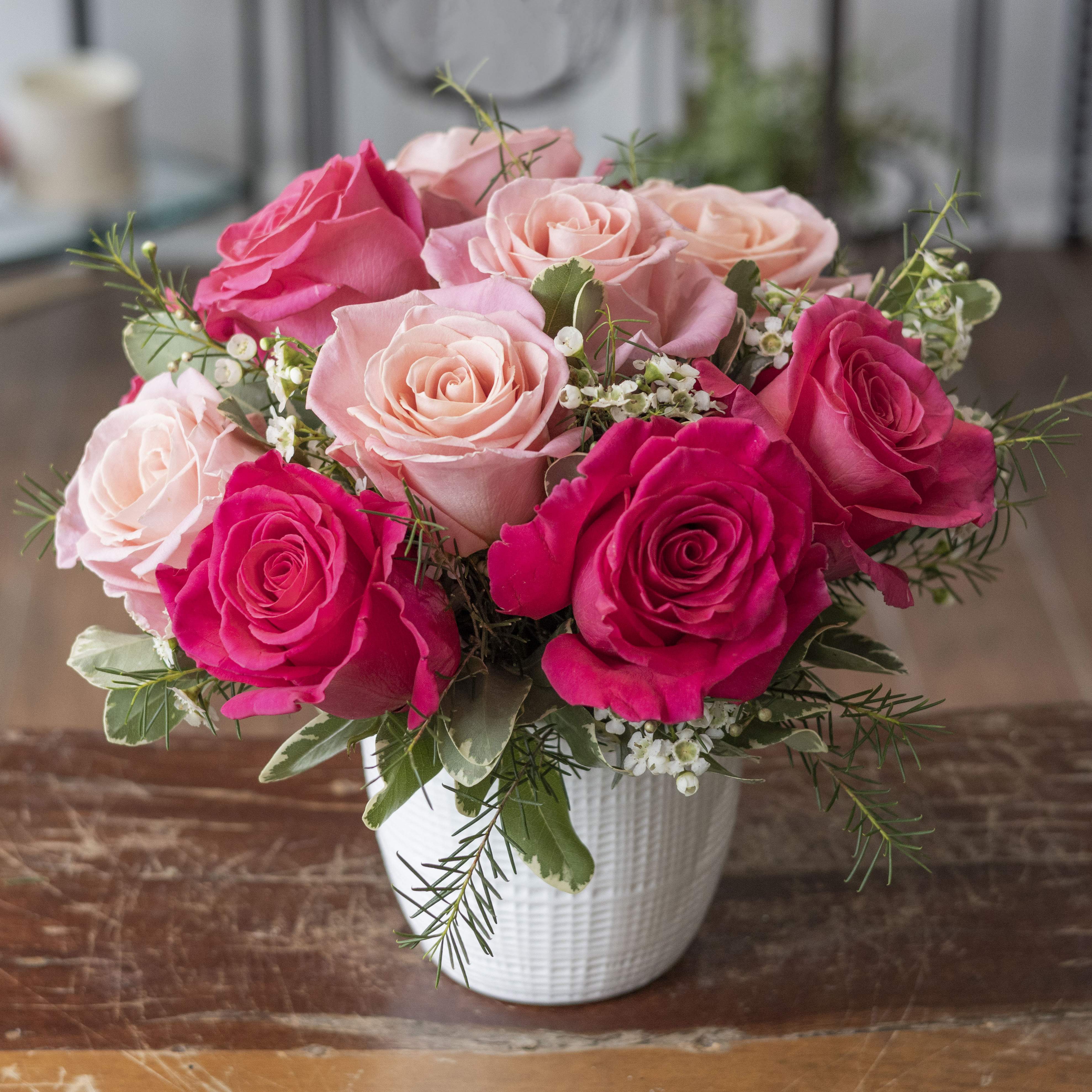 Eleanor - One dozen hot pink and light pink roses in a short design, arranged in a white ceramic vase