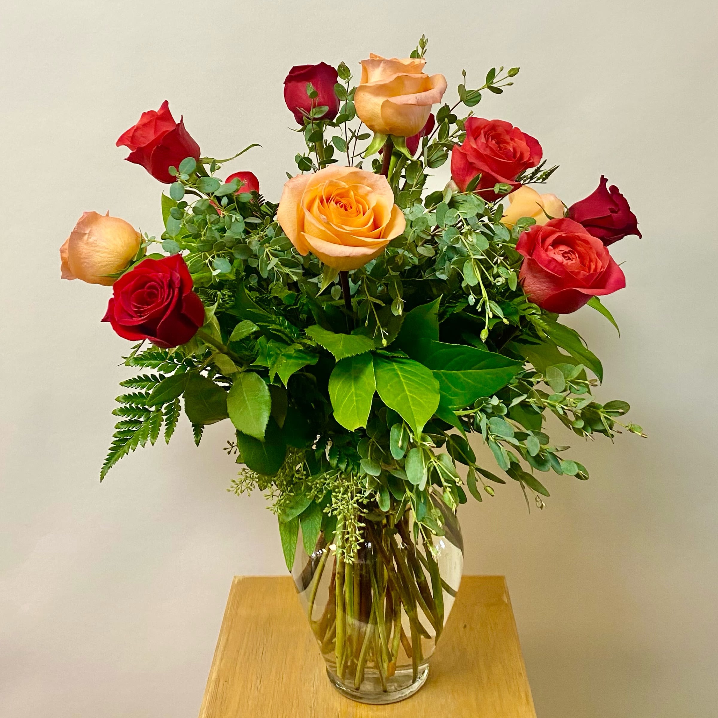 Fall Dozen Roses - This Arrangement Includes X-Pression Roses, Coral Reef Roses, Red Roses and Greenery in a Glass Vase. Or as Similar as Possible. 