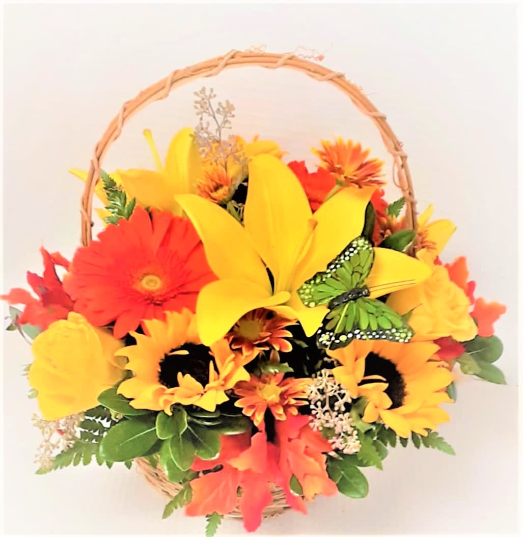 Fall Giving Basket - A perfect thank you or any occasion in a woodland basket filled with lilies, roses, sunflowers and other fall flowers and leaves.