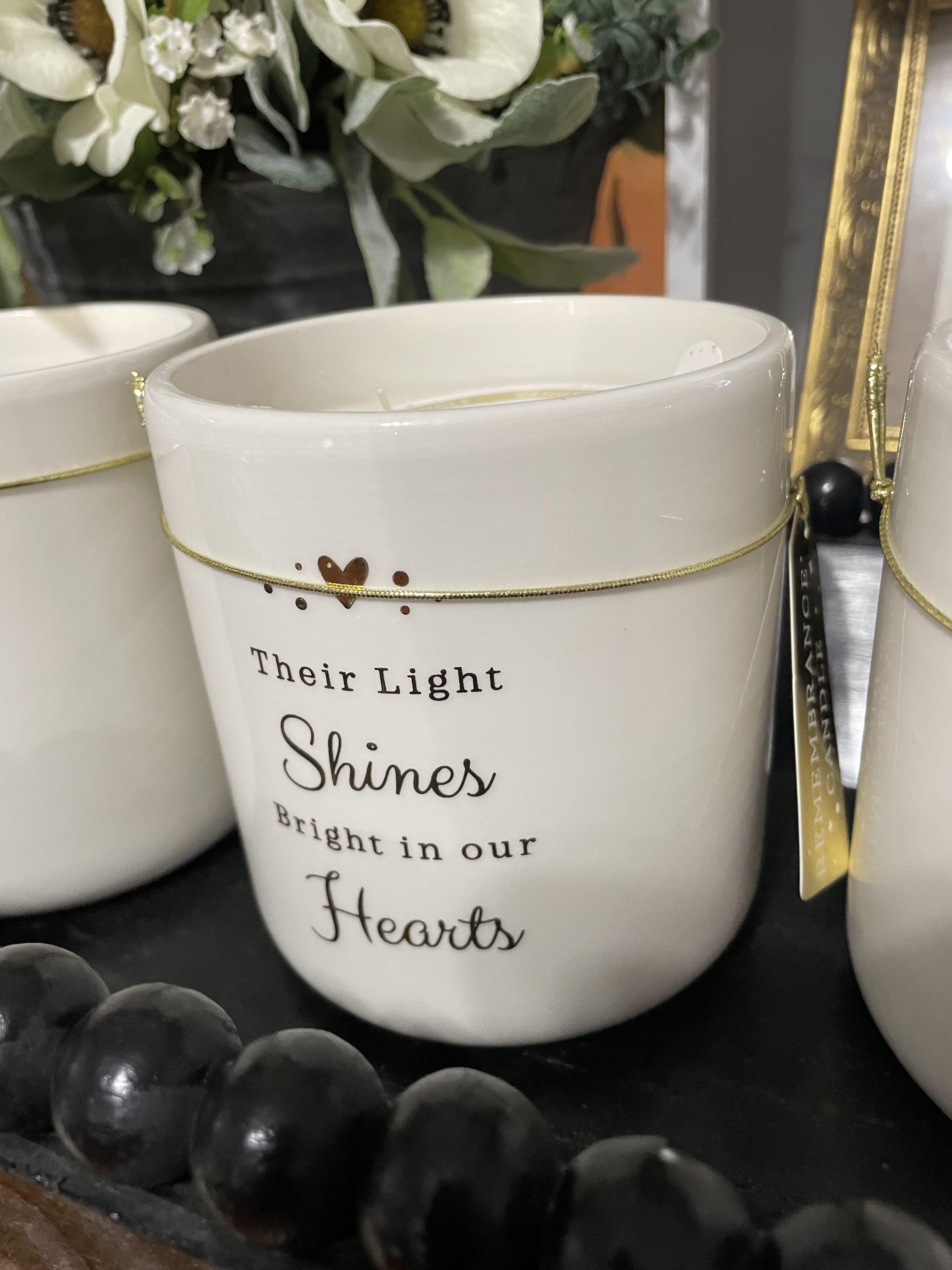 Remembrance Jar Candle - Our Remembrance Vanilla Bean 1-Wick Jar Candle emits a light, sweet scent that creates a comforting ambience. The heartfelt sentiment makes it a thoughtful gift for anyone who has lost a loved one.  Candle measures 3.4H x 4.1 in. in diameter 18.7 oz. Vanilla candle White ceramic jar container Features the text &quot;Their light shines bright in our hearts&quot; Paraffin wax