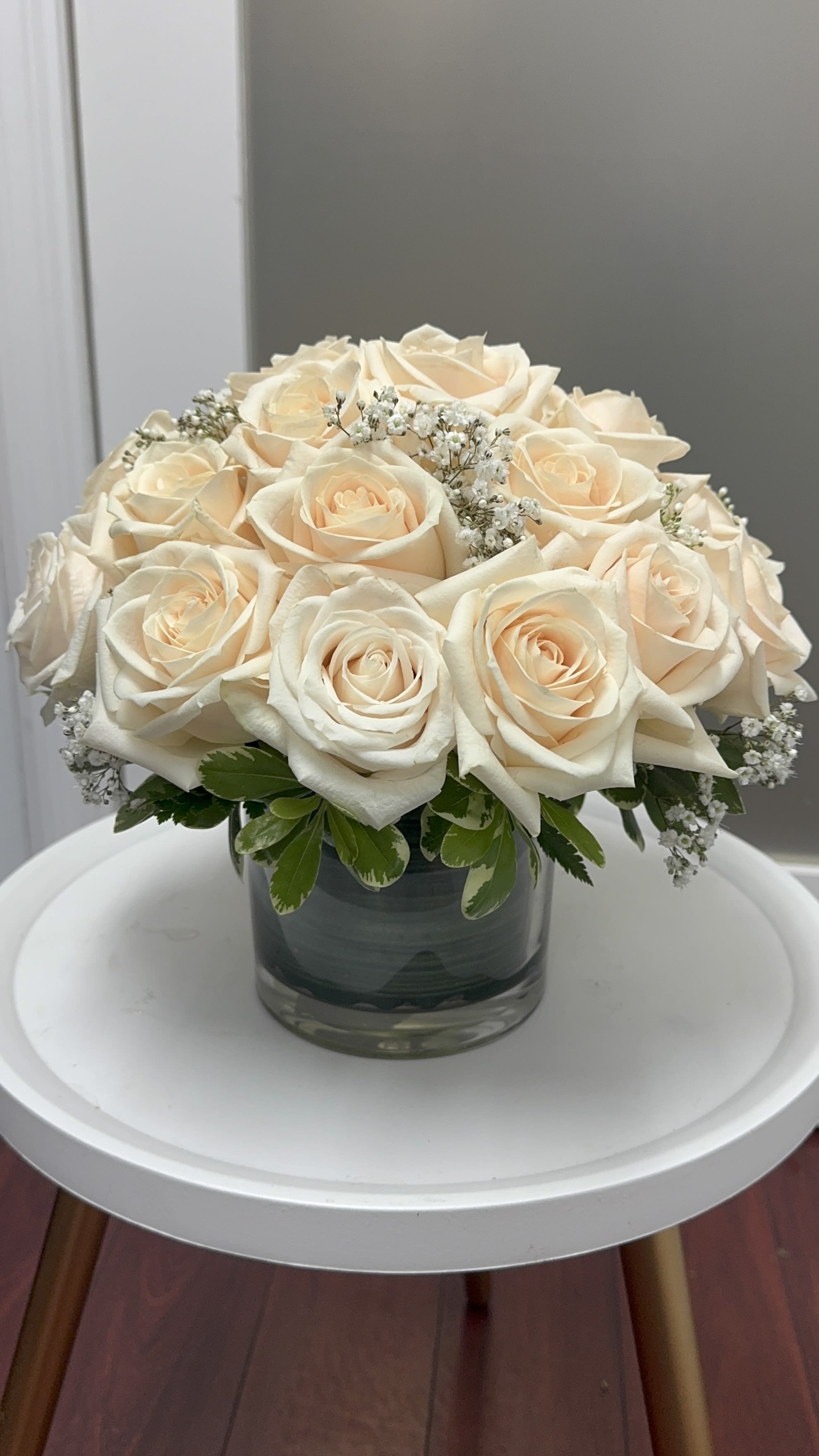 Two Dozen White Roses by BloomNation™ - Make a bold statement with this elegantly simple design. White roses symbolize hope, honor, adoration, and innocence. Two Dozen White Roses by BloomNationâ¢ is the perfect gift to welcome new beginnings or show your respects. 