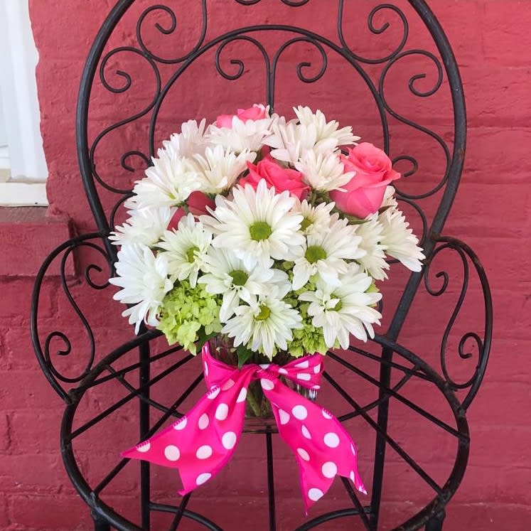  Teleflora's Polka Dots and Posies - Polka dots and posies, they're the perfect pair. Well, at least in this pretty arrangement they are. Just the right flowers in just the right vase all wrapped up in… you guessed it, just the right ribbon.  Pink spray roses and white daisy spray chrysanthemums are delivered in an exclusive pink vase that's wrapped with a polka-dot satin ribbon.
