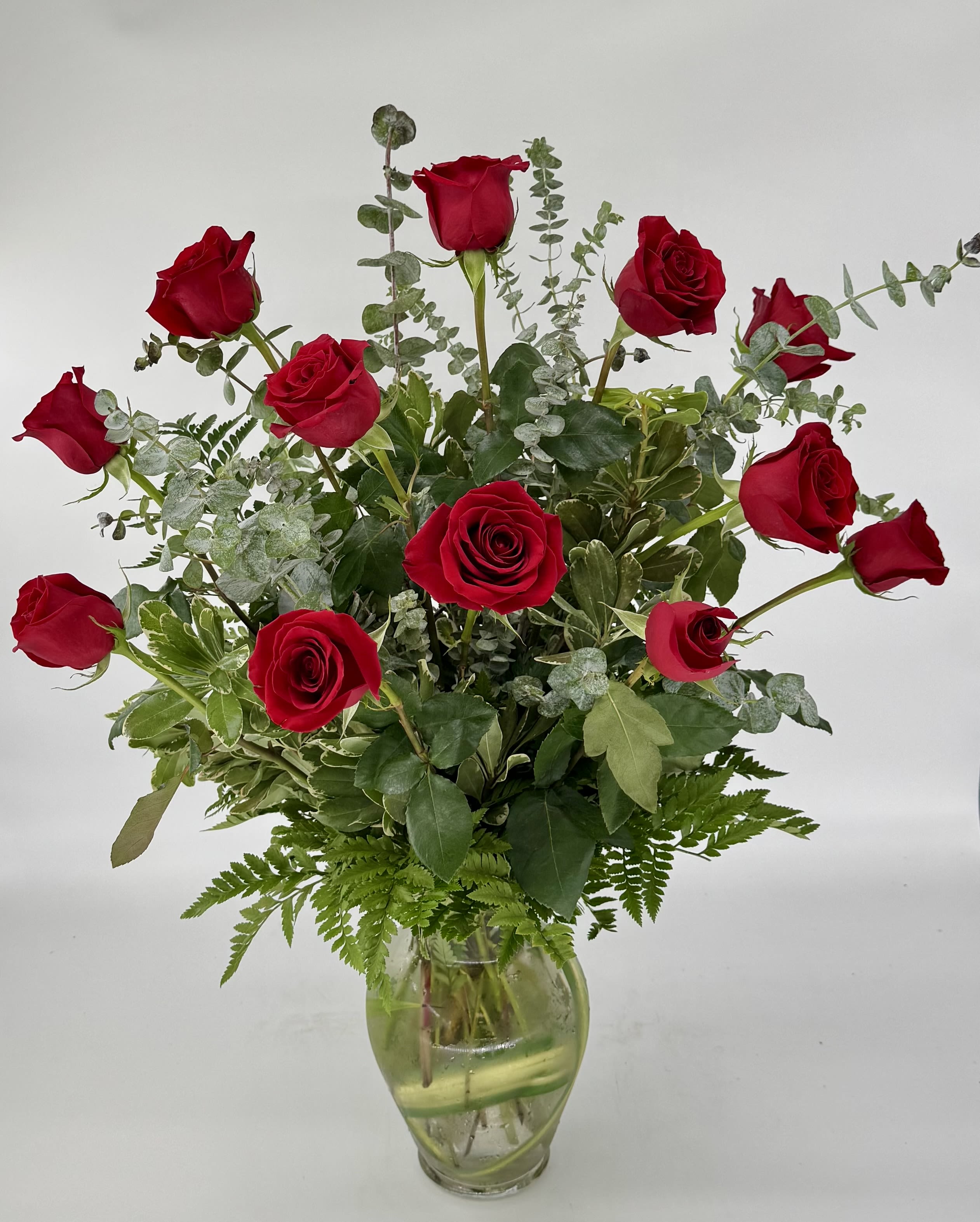 One Dozen Red Roses  (BR) - Delight your loved one with a stunning display of affection. Our dozen red roses with greenery and filler is the perfect expression of love and passion.