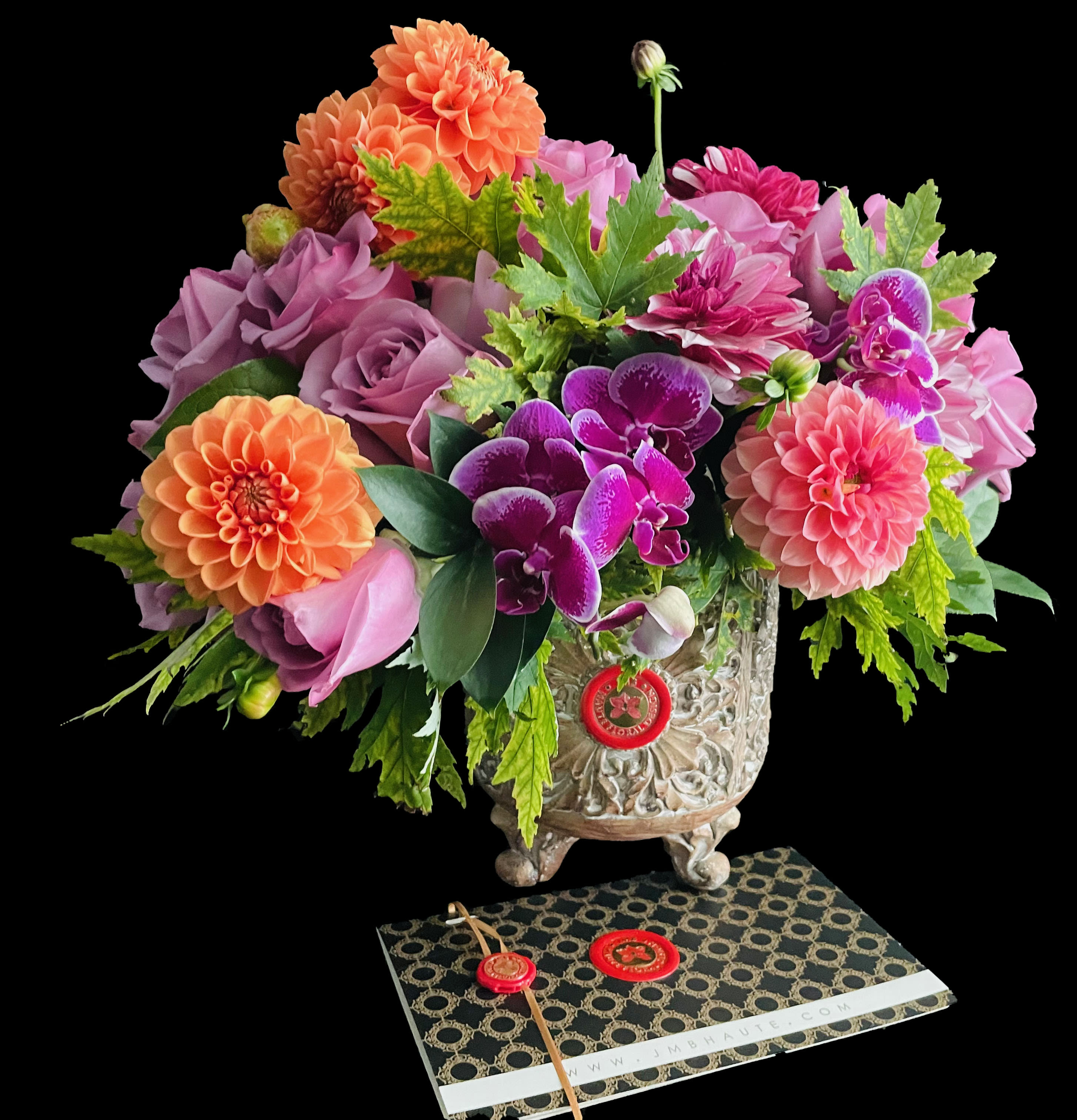 Carved Compote Blooms - A combination of roses, dahlias and orchids in our carved footed compote. Quantity of blooms and vase size ( 3 sizes available) depends on chosen price point. Pictured size Premium