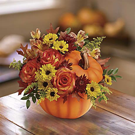 Warm Wishes Pumpkin Bouquet - Celebrate the beauty of fall with this colorful, heartwarming mix of roses and alstroemeria, hand-delivered in our classic ceramic pumpkin. Includes a lush mix of orange roses, orange alstroemeria, burgundy cushion chrysanthemums, yellow daisy chrysanthemums, solidago, and oak leaves. Delivered in Teleflora's exclusive ceramic pumpkin with lid. Orientation: All-Around