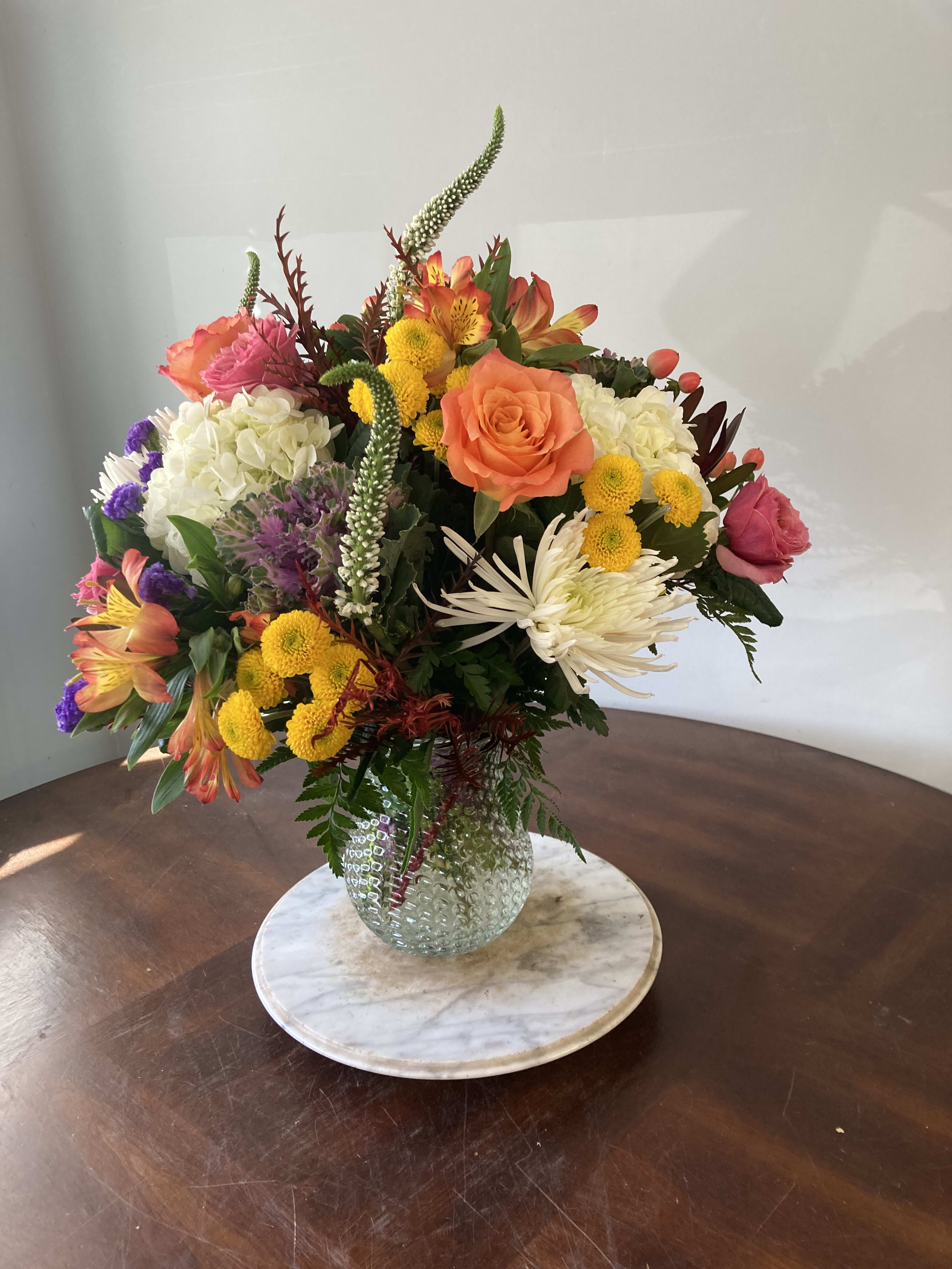 fall is in the air - vase with hydrangeas, roses, kale, and other seasonal flowers