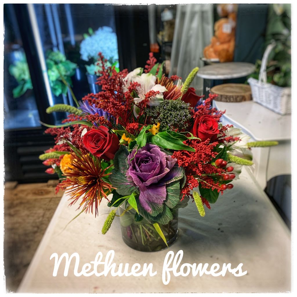 fall in love - clear vase with beautiful fall colored flowers such: kale, roses, trachilium, spider mums, and more
