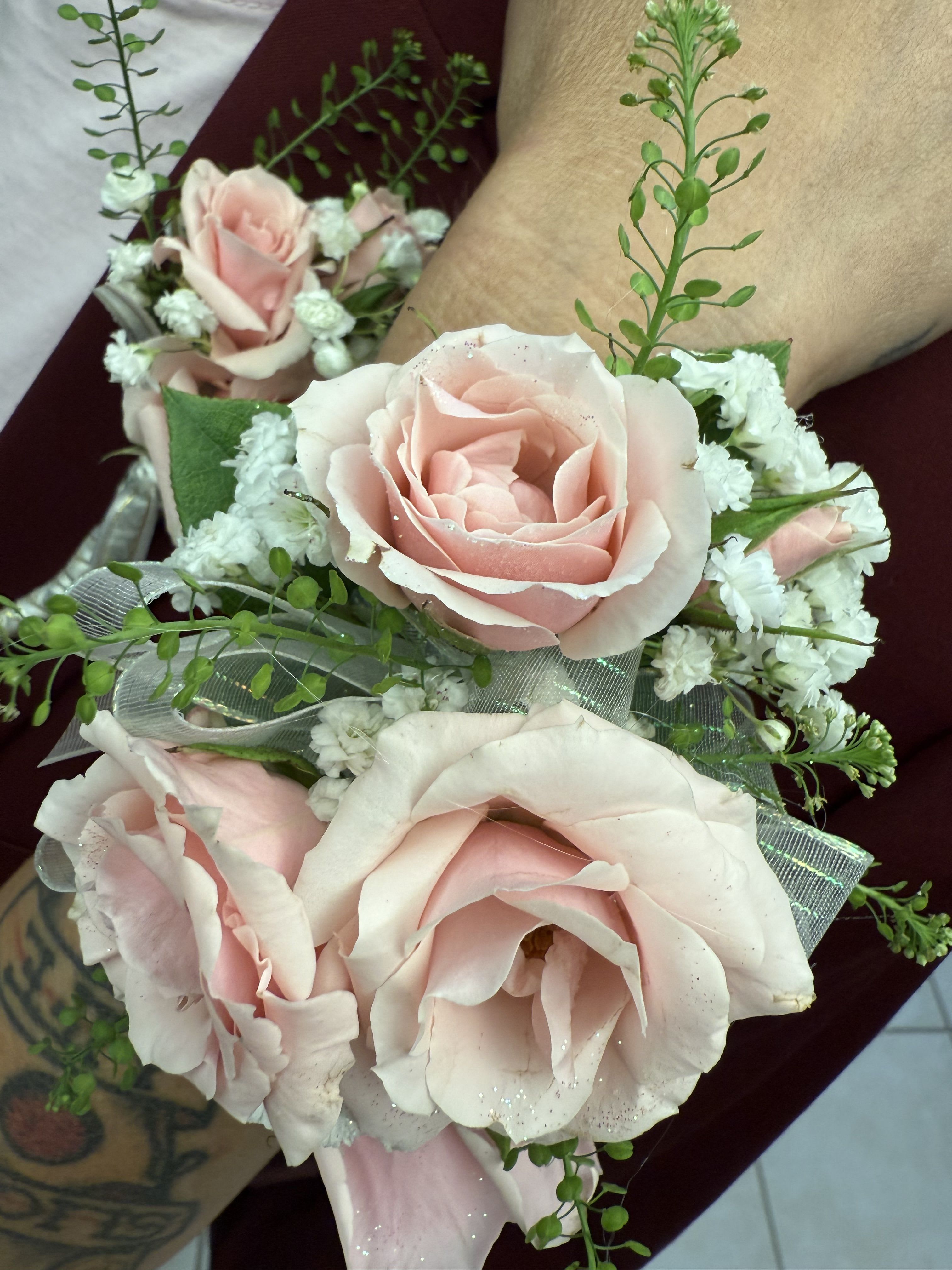Corsages and Boutonnieres - Celebrate with custom designed Corsage and/or Boutonniere.  A beautiful selection of wristlet and pin on corsages, along with Boutonnieres for home coming, proms and special events.  Roses, Orchids, Carnations, creatively designed working with your special color palette. 