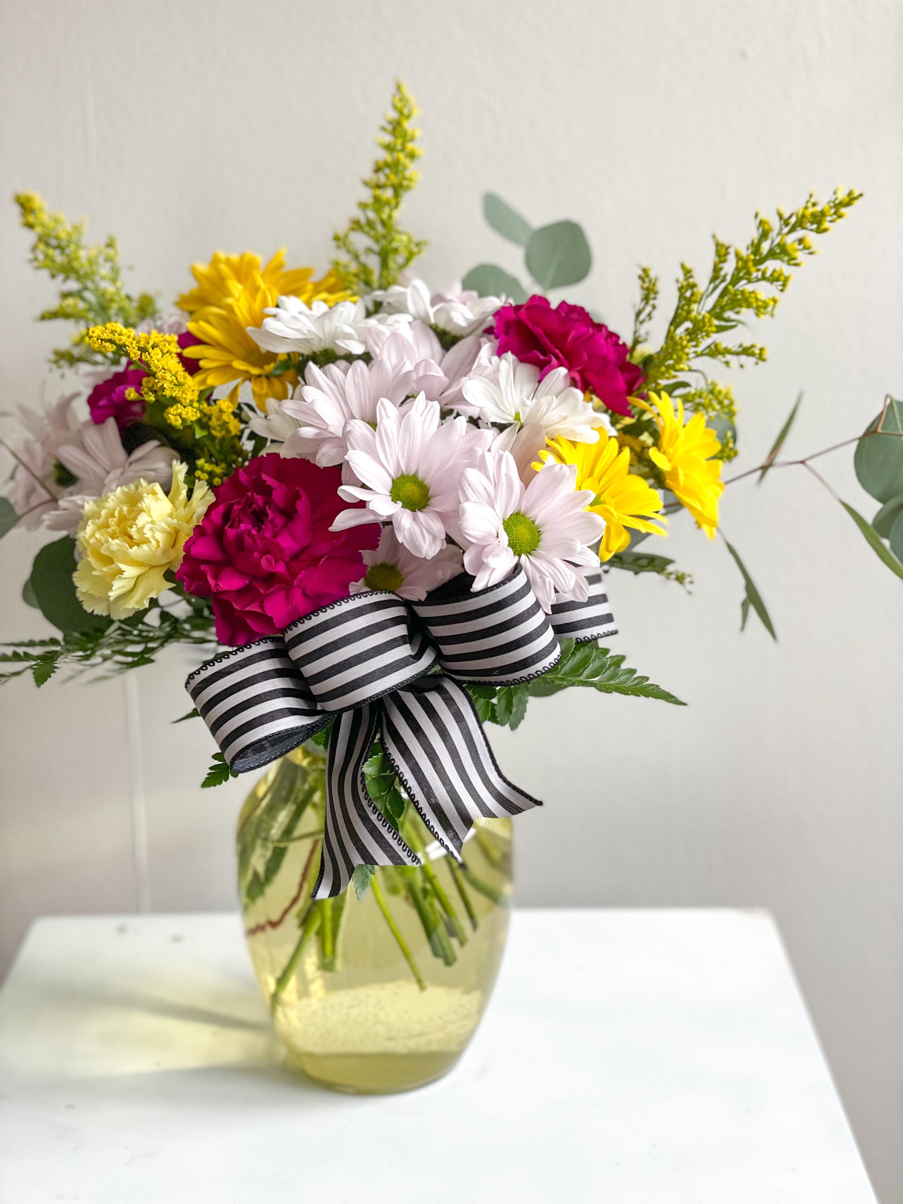 Carla  - The Carla is a daisy and carnation mix. Vase color may vary.