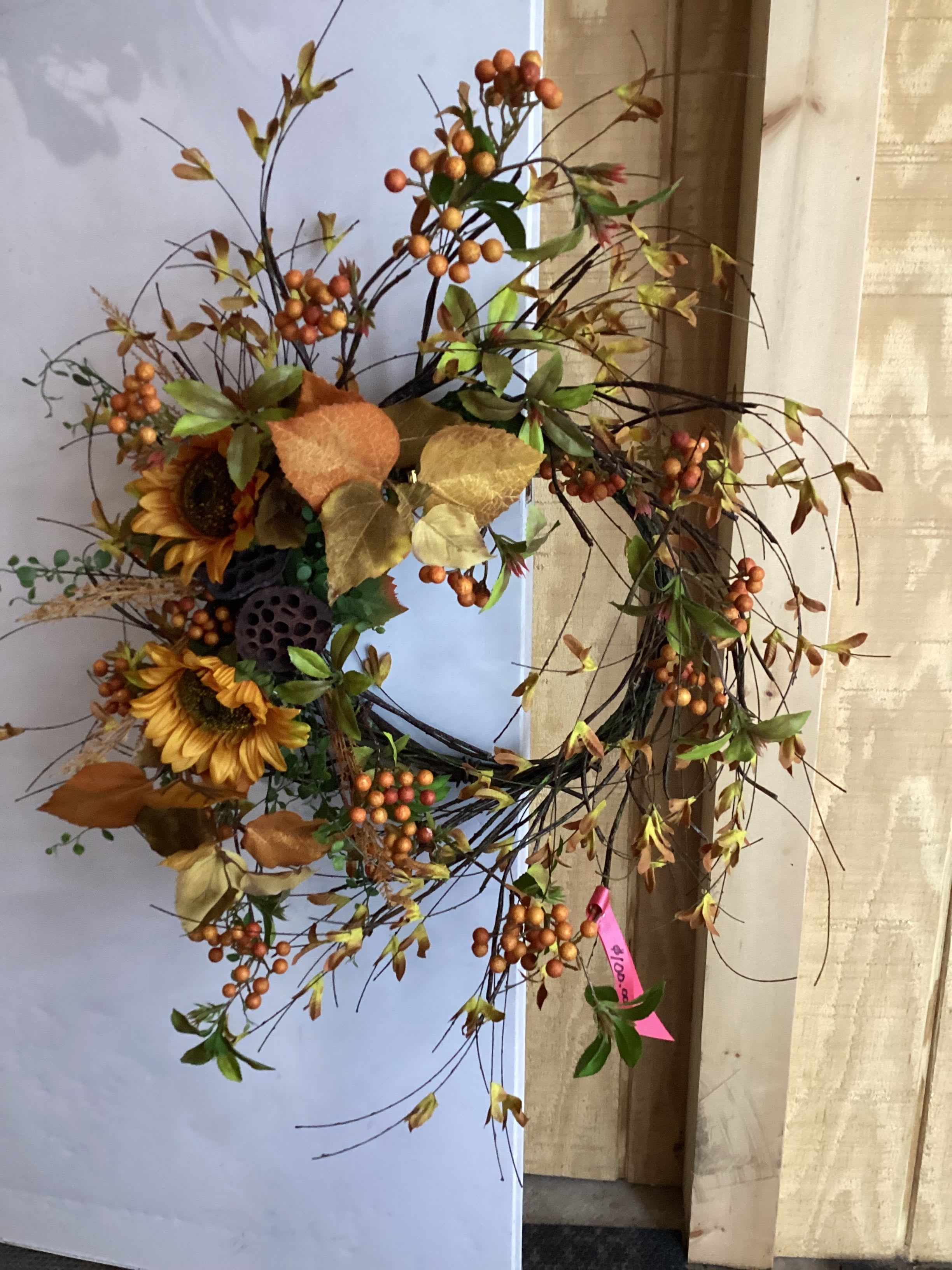 Sunflower and Autumn Leaves Wreath  - A wreath decorated in warm tones with autumn leaves and sunflowers