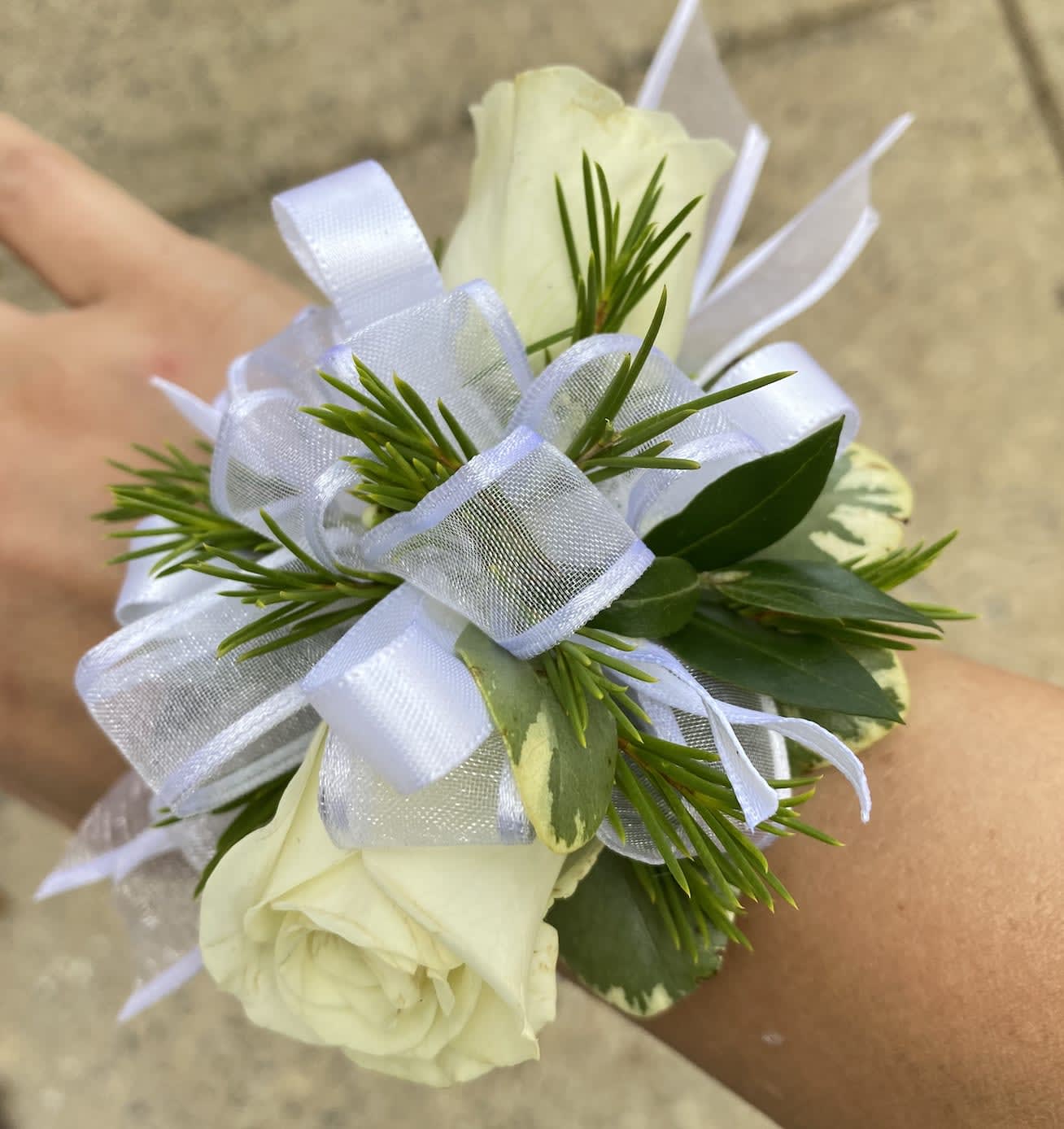 Pure White Corsage  Pure White Corsage  - This elegant corsage features spray roses, embellished with pittosporum and a matching white ribbon.