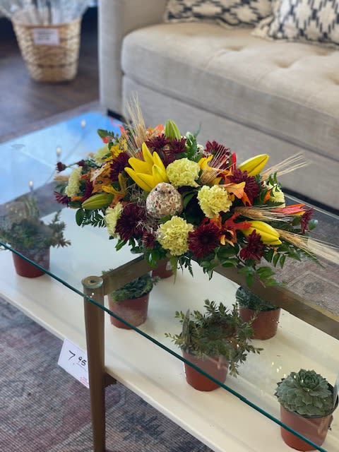 Boho birdy centerpiece  - Fall flowers in a nice mix with a cute lil boho bird friend. Perfect for a family gathering.