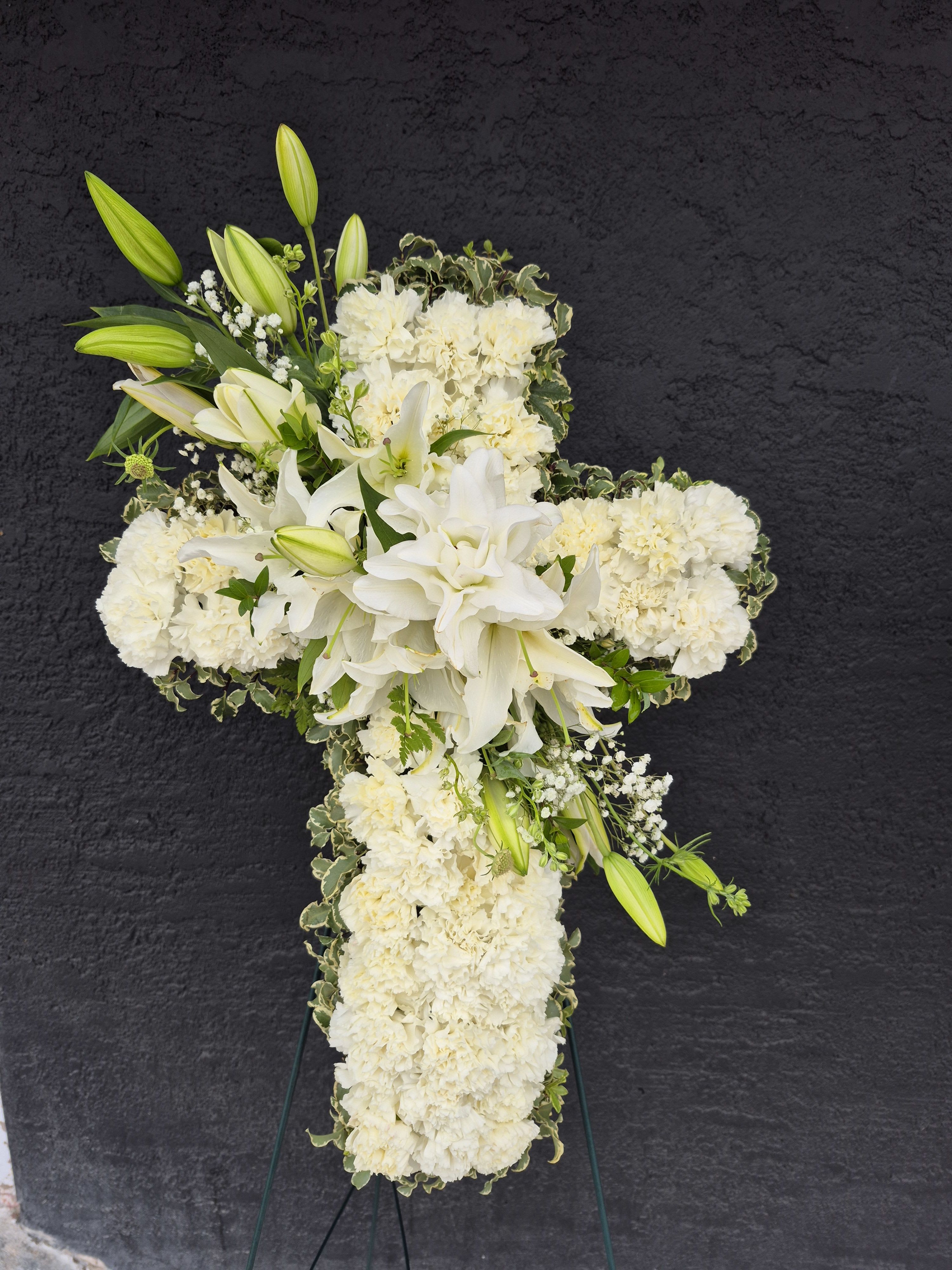 Heavenly Cross  - The cross made with beautiful white carnations with bloomed oriental lilies in the center. A sunning choice to honor your loved one.  We include easel, printed banner, and delivery (some fees may apply). Additional banner can be added for $40.  Standard- Approximately 16&quot;W x 22 H&quot; Deluxe - Approximately 18&quot;W x 26&quot; H Premium- Approximately 20&quot;W x 30&quot;H  Available Height Size: 22&quot;, 26&quot;, or 30&quot; 