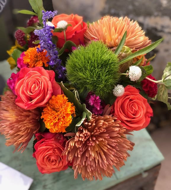 Autumn - Array of fall tones including , sunflowers, chrysanthemums, roses, dianthus,  and a beautiful mix of seasonal fillers in a clear glass vase.