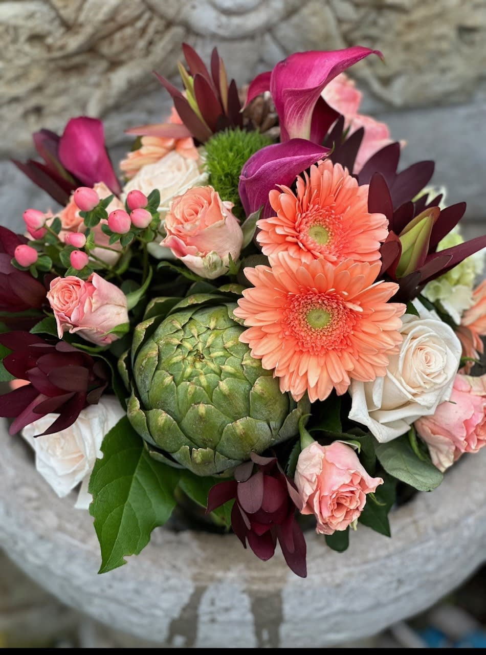 Aruba Nights - A beautiful combination of Coral Roses, Calla Lily's, Peach Gerbera Daisies, Hypericum berries and more.  Reminiscent of a sunset on Palm Beach.
