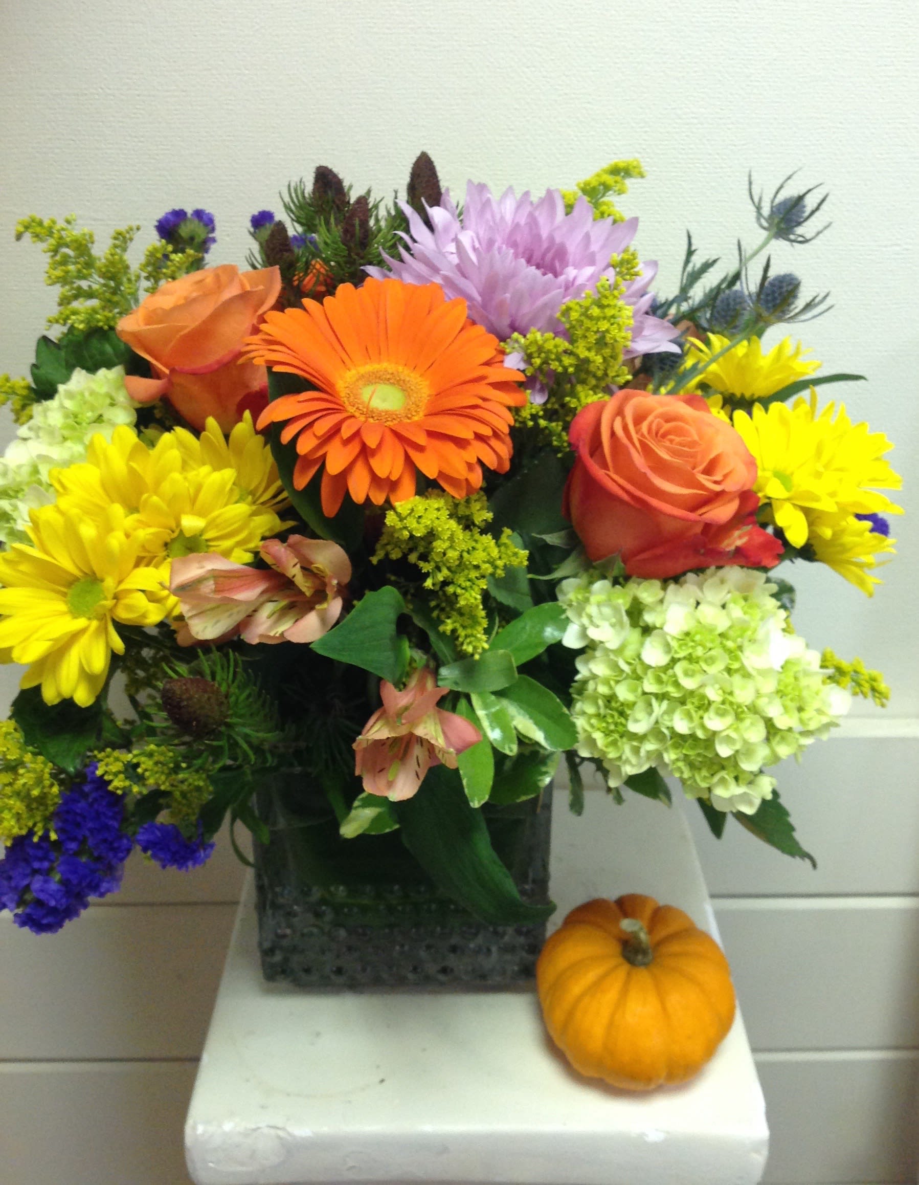 Summer into Fall - fall colors and flowers including alstroemeria. gerber daisy and mums attended in a glass cube