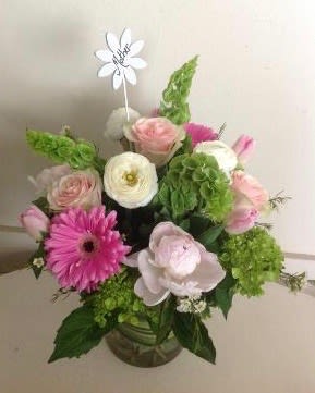 Queen for a day - Show Mom how much you care with this stunning collection of peonies, roses,  tulips, ranunculus, bells of ireland and hydrangea Arranged in a glass cylinder and topped with a handwritten &quot;mother flower stick&quot;. 