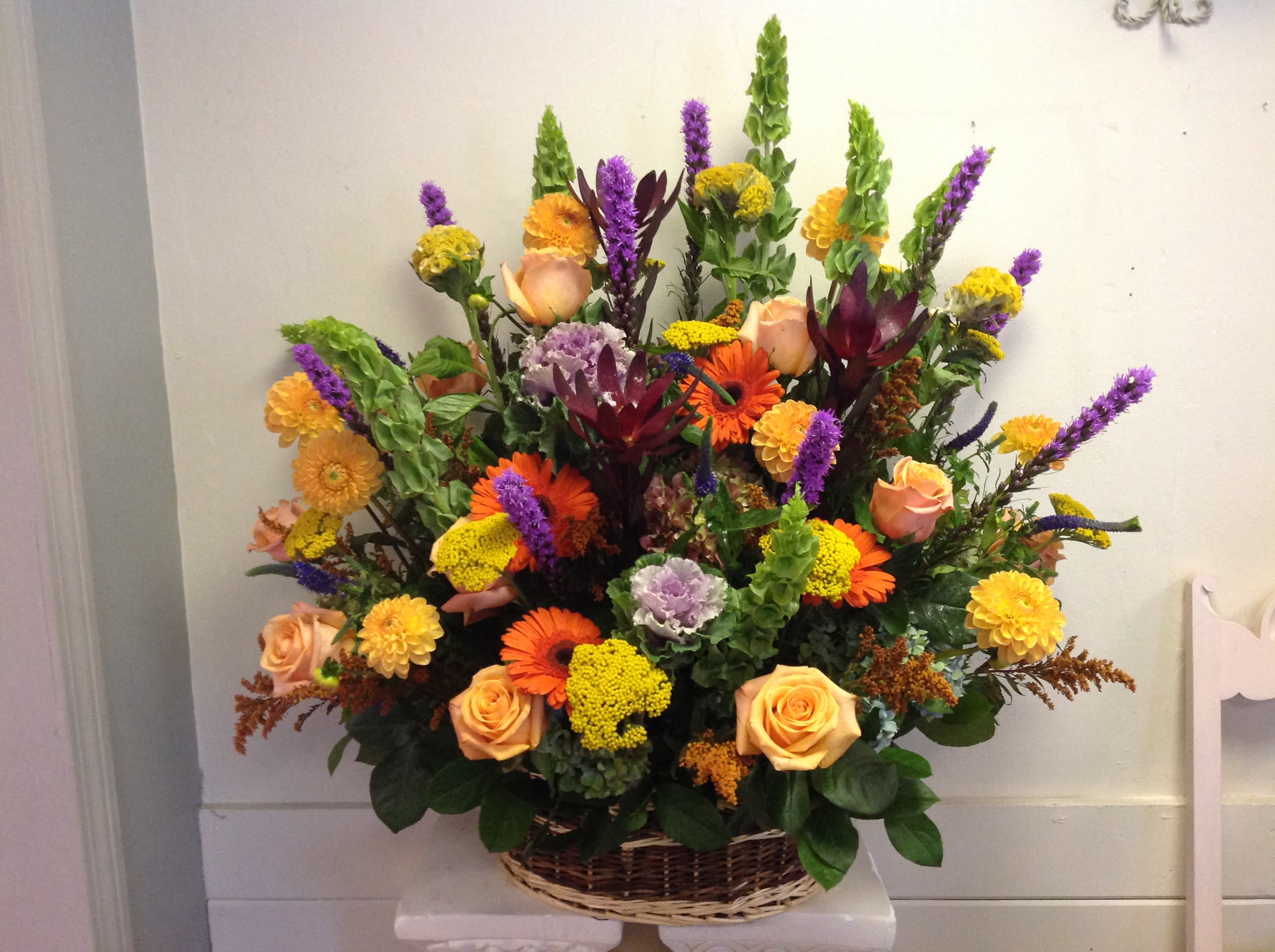 Fall Tribute - Basket of fall colors and blooms including gerbera daisies,roses, bells of Ireland and kale