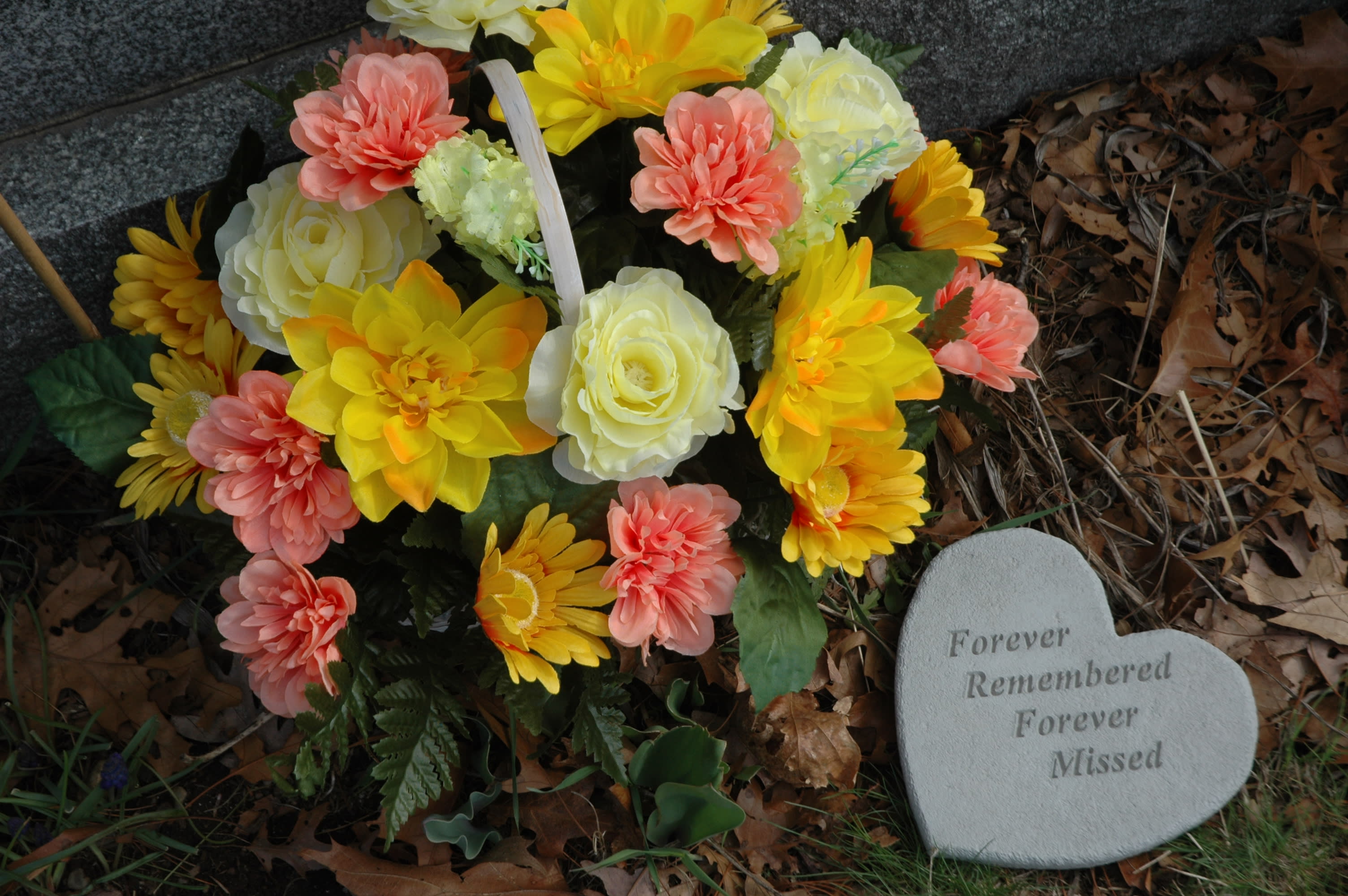 Forever Remembered Forever Remembered - Silk floral in sturdy log planter in assorted spring colors. Combine with carved stone heart rock with "forever remember, forever missed" sentiment...... will deliver to Blue Hill Cemetery