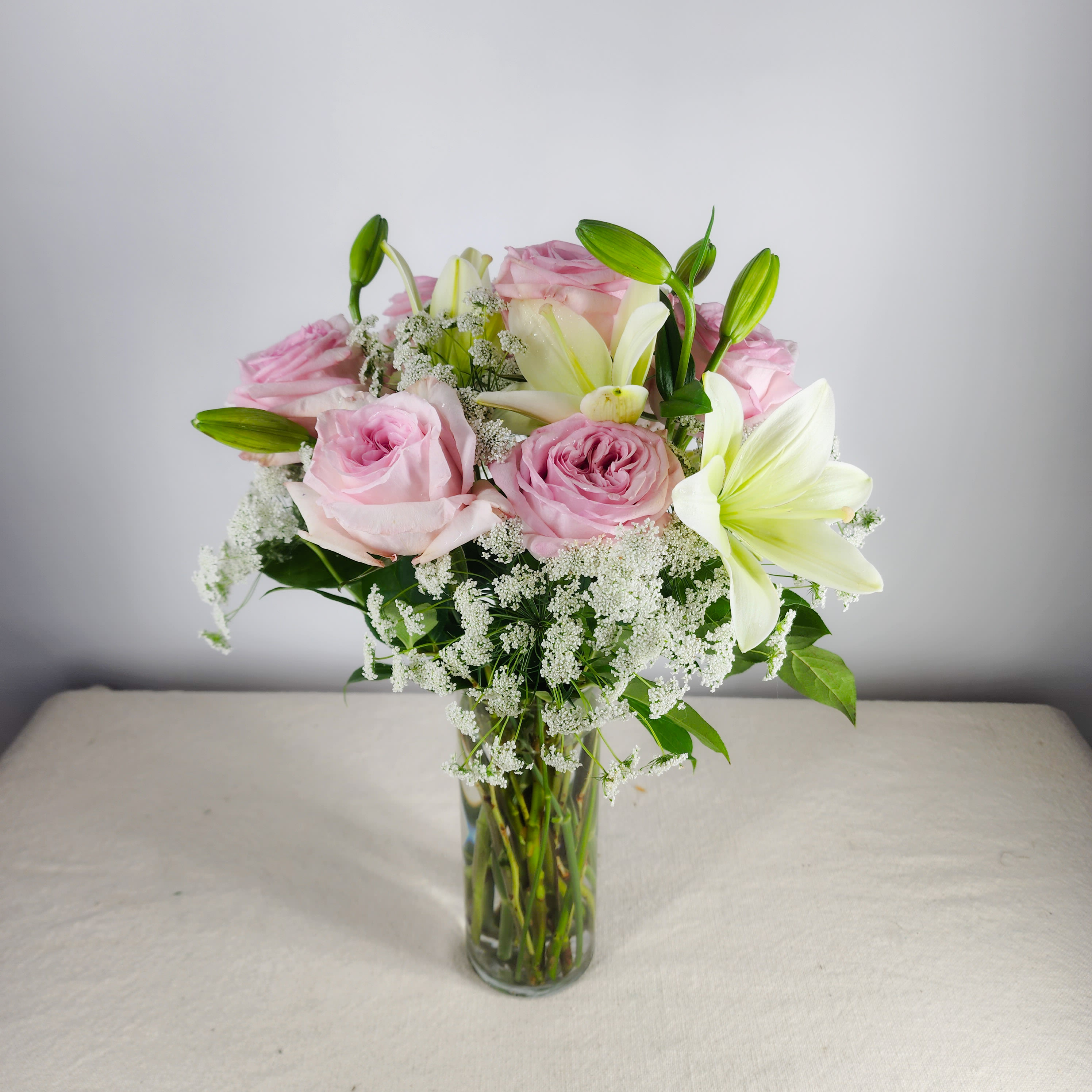 Roses Fit for a Queen - Queen Anne's lace is sprinkled around roses and lilies. This beautiful arrangement is fit for any Queen. Rose color can be changed. Roses can be upgraded to fragrant garden roses. PS. Lilies are deadly toxic to cats.