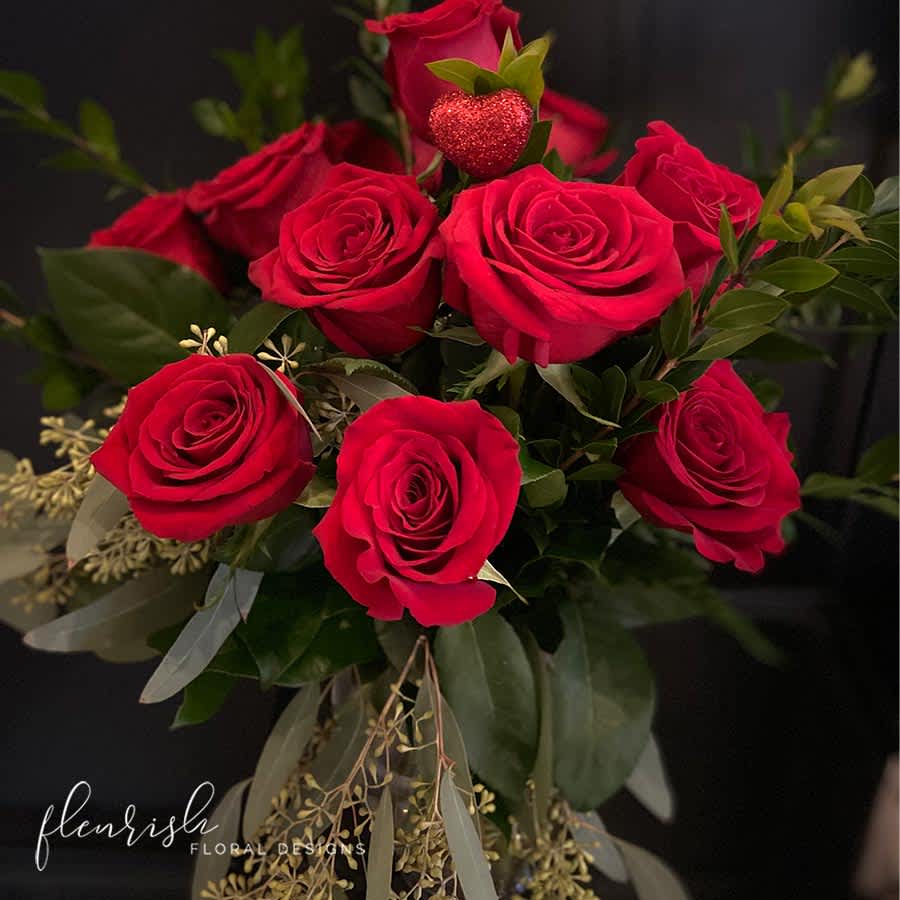 Unchained Melody - Woah, my love, my darling... Our take on a traditional vase of a dozen velvety red roses with unique mixed greens. Standard: 1 dozen roses Deluxe: 2 dozen roses