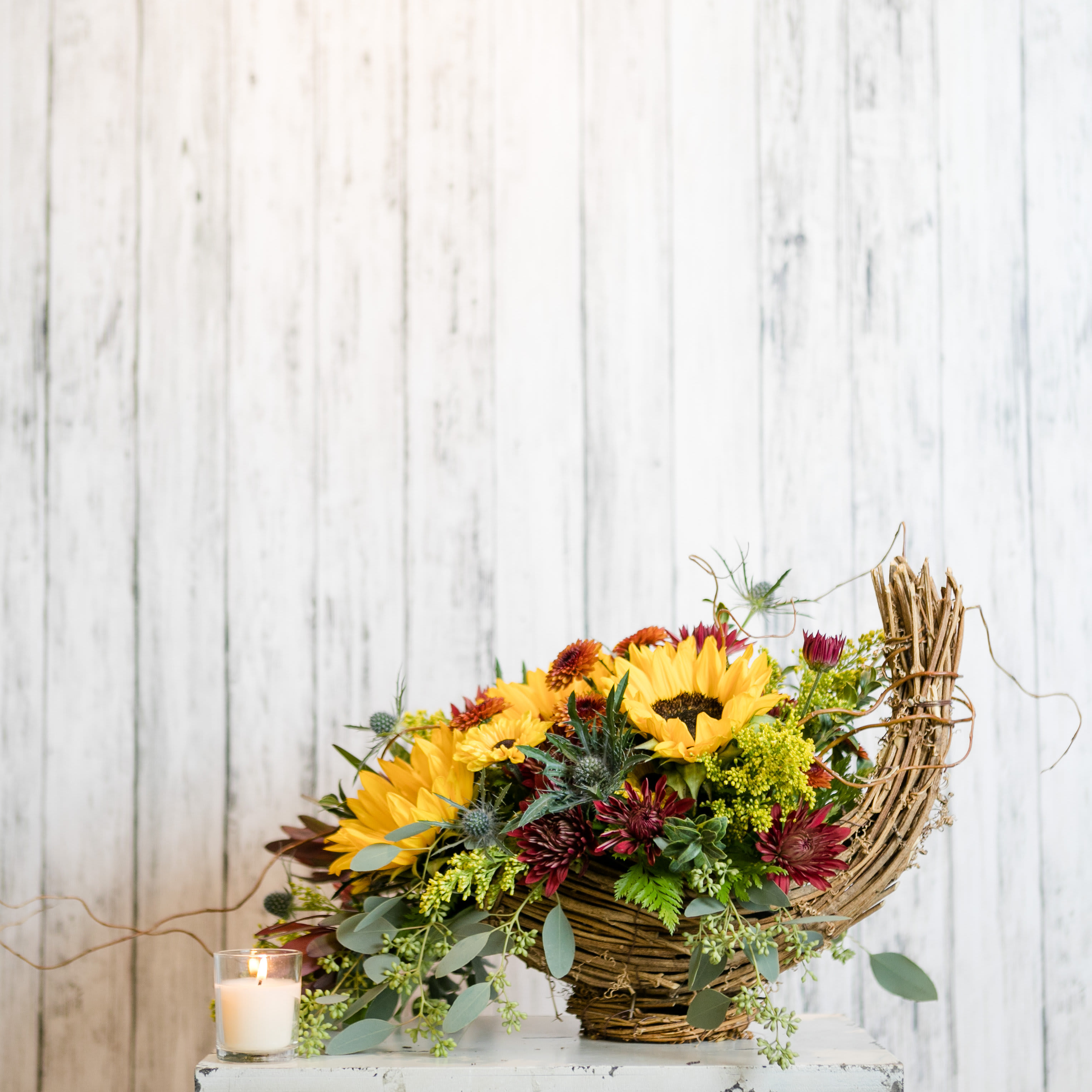Bountiful - Celebrate autumn with a cornucopia basket overflowing with sunflowers, mums, 