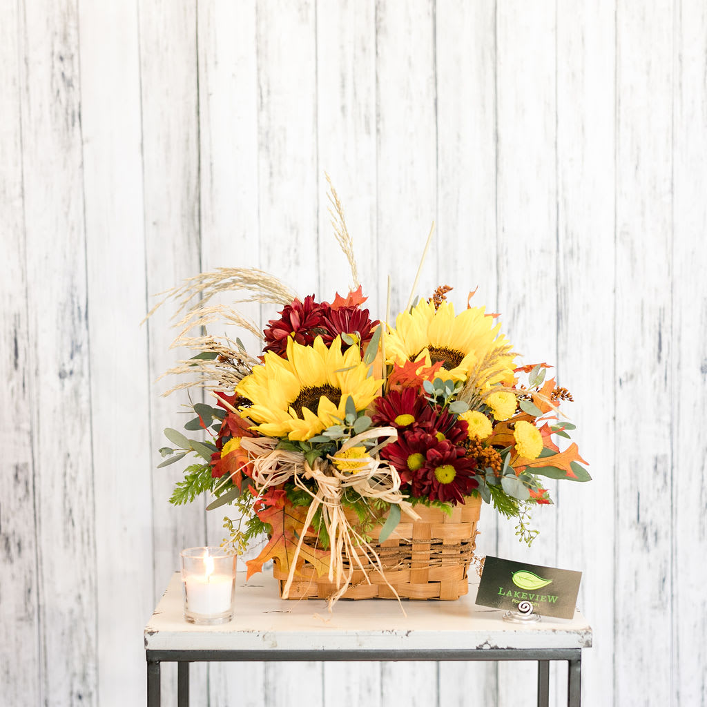Sunset - Send sunshine with a basket of sunflowers, rich-toned chrysanthemums, autumn leaves and textural foliage!  Approximate Dimensions: 14&quot; T X 13&quot; W