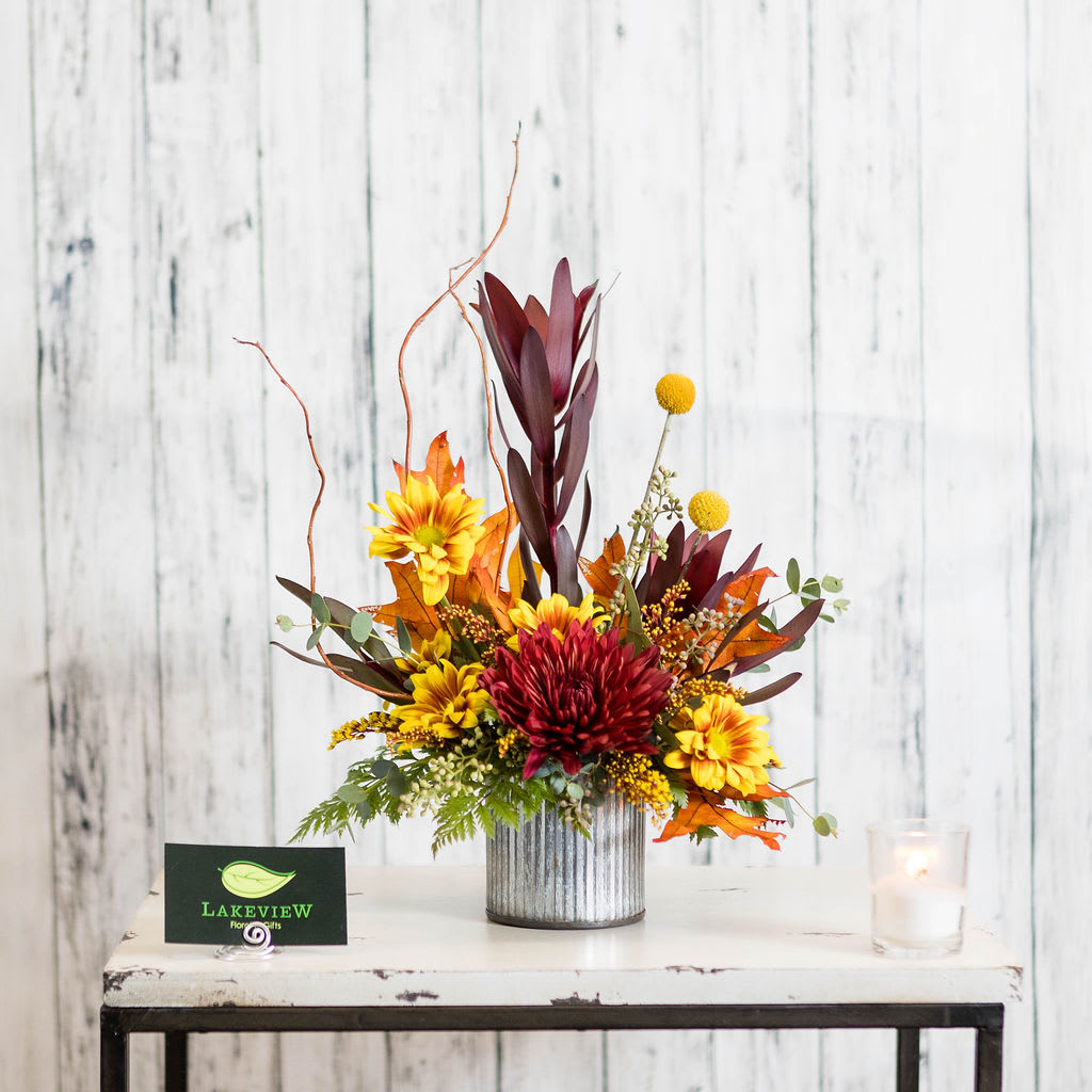 Amber - Simple, sweet and petite!  This desktop sized arrangement features the best of fall in long-lasting burgundy, gold and orange.  Approx.: 14&quot;H x 10&quot;W