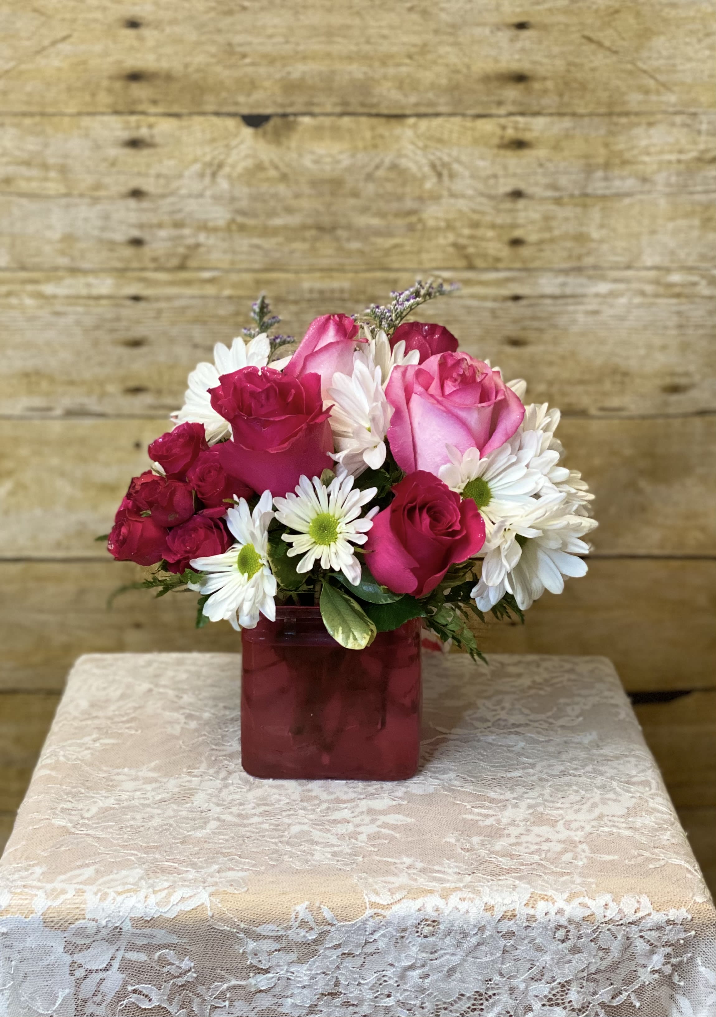 Daisy Me Rollin' by BloomNation - This arrangement contains spray daisies and roses.