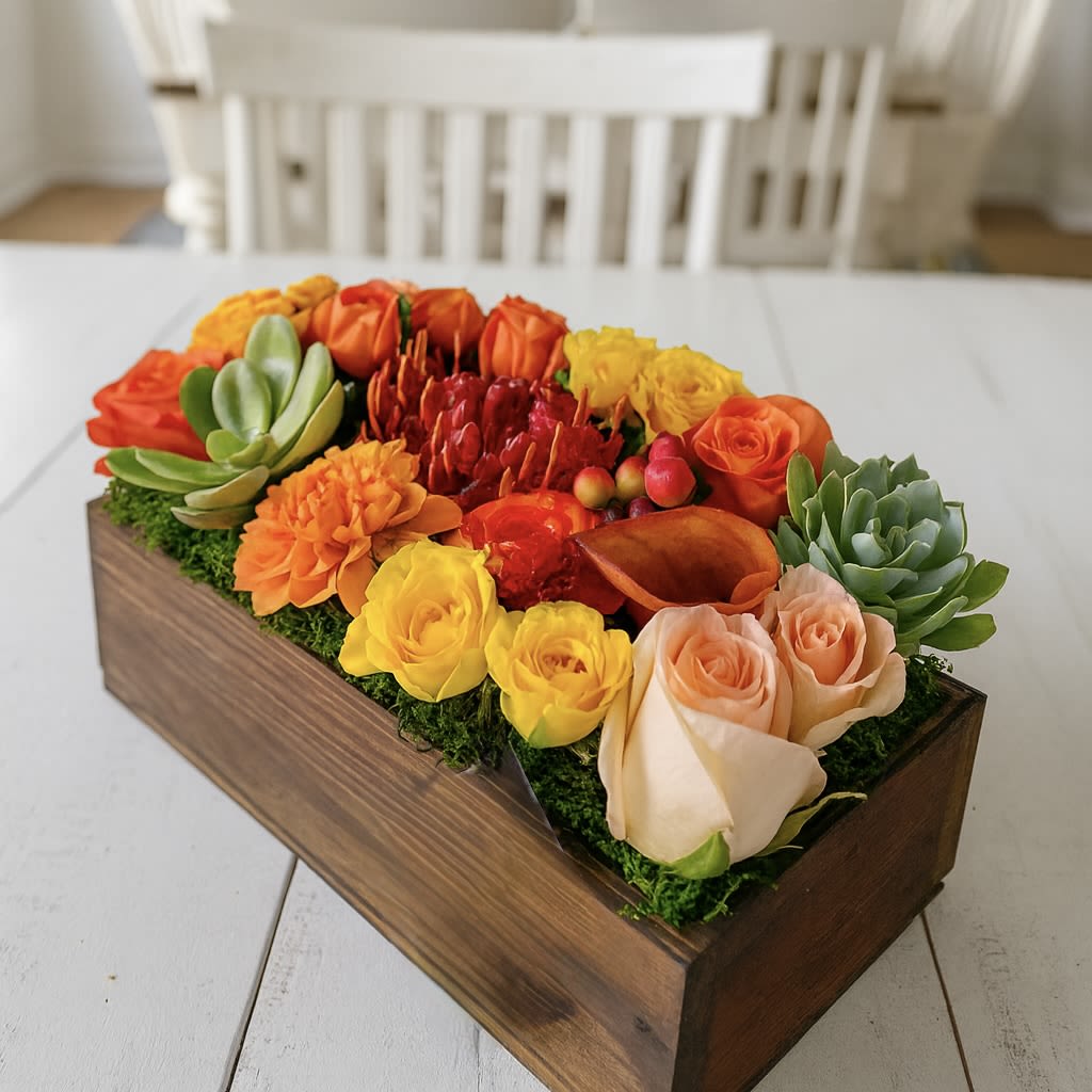 Good Vibrations  - Introducing Good Vibrations - the perfect gift for your family and friends! This exquisite arrangement of seasonal flowers in yellow, red, orange, and burgundy, along with lush succulents, will be sure to leave your loved ones feeling vibrant and energized. Featuring a delightful mix of vibrant hues nestled in a sleek and wood-like rectangular box, Good Vibrations will spread a positive wave of happiness and good vibes upon delivery. Gift it to your family and friends and share the good vibes with them!