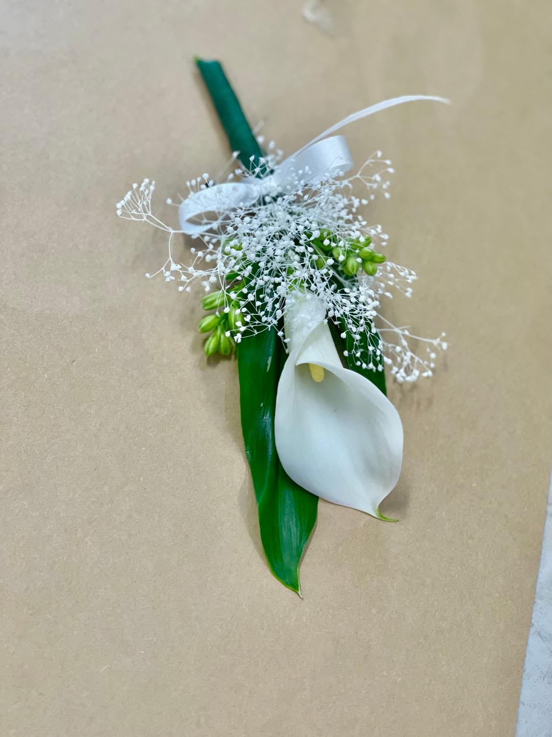 Timeless Boutonniere Timeless Boutonniere - Made from fresh flowers, a boutonniere looks like a petite flower arrangement (typically consisting of just one or several smaller blooms) pinned on a lapel. Boutonniere serve as a way to honor people who are very important to the couple getting married. Please contact our shop at (747) 249-4678 for any customization.