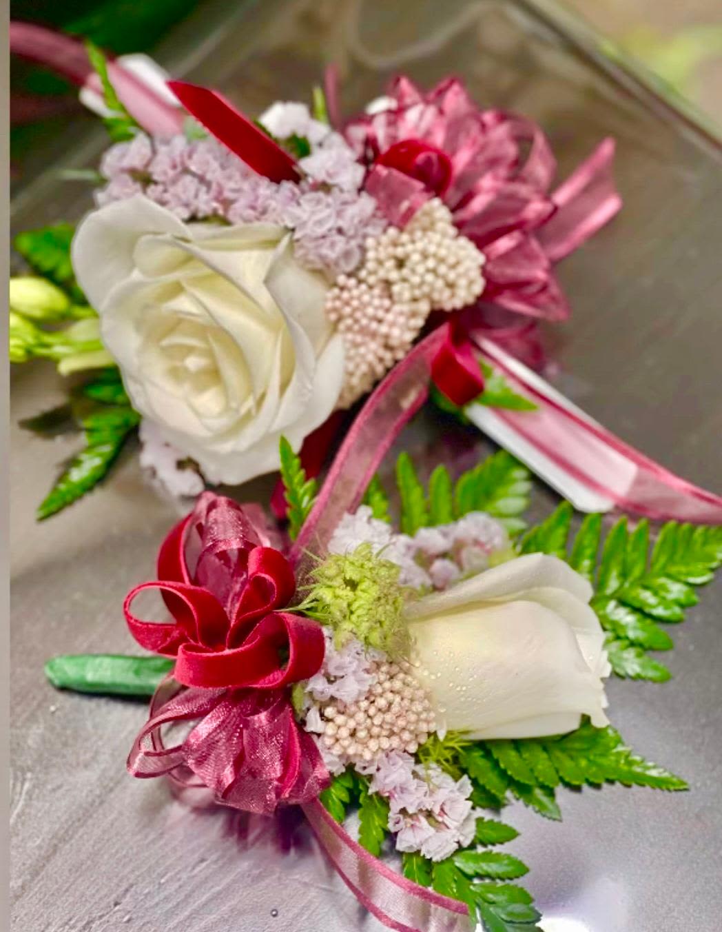 Vintage Bloom Corsage and Boutonniere Set - Made from fresh flowers, a corsage looks like a petite flower arrangement (typically consisting of just one or several smaller blooms) and usually sits on the wrist like a bracelet, though it can also be pinned on a lapel. Corsages serve as a way to honor people who are very important to the couple getting married. Please contact our shop at (747) 249-4678 for any customization. 