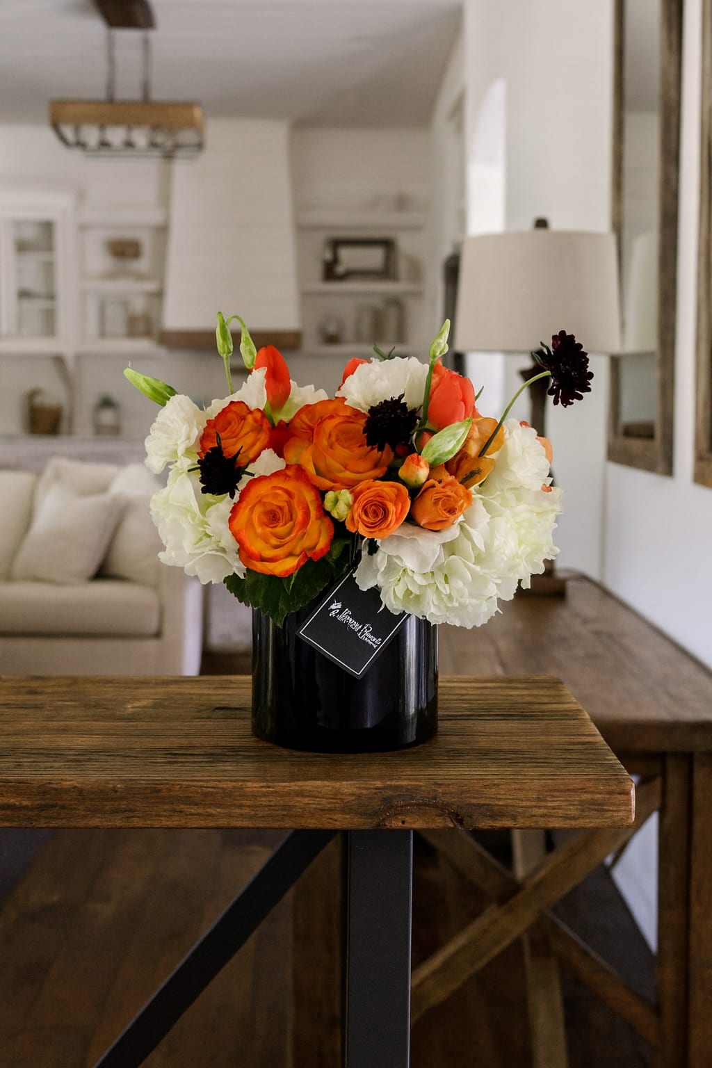 The Oxy - Introducing the Oxy Arrangement, the gift that packs a punch! Tell your family and friends that they’re special with a beautiful 5x5 black cylinder of delicious oranges and whites. The unique combination of rich orange roses, vibrant spray roses, luscious orange tulips, white hydrangeas and stunning scabiosa flowers create a stunning display that will make a lasting impression. So surprise your loved ones the Oxy way! They will thank you for such a witty and lovely gift.