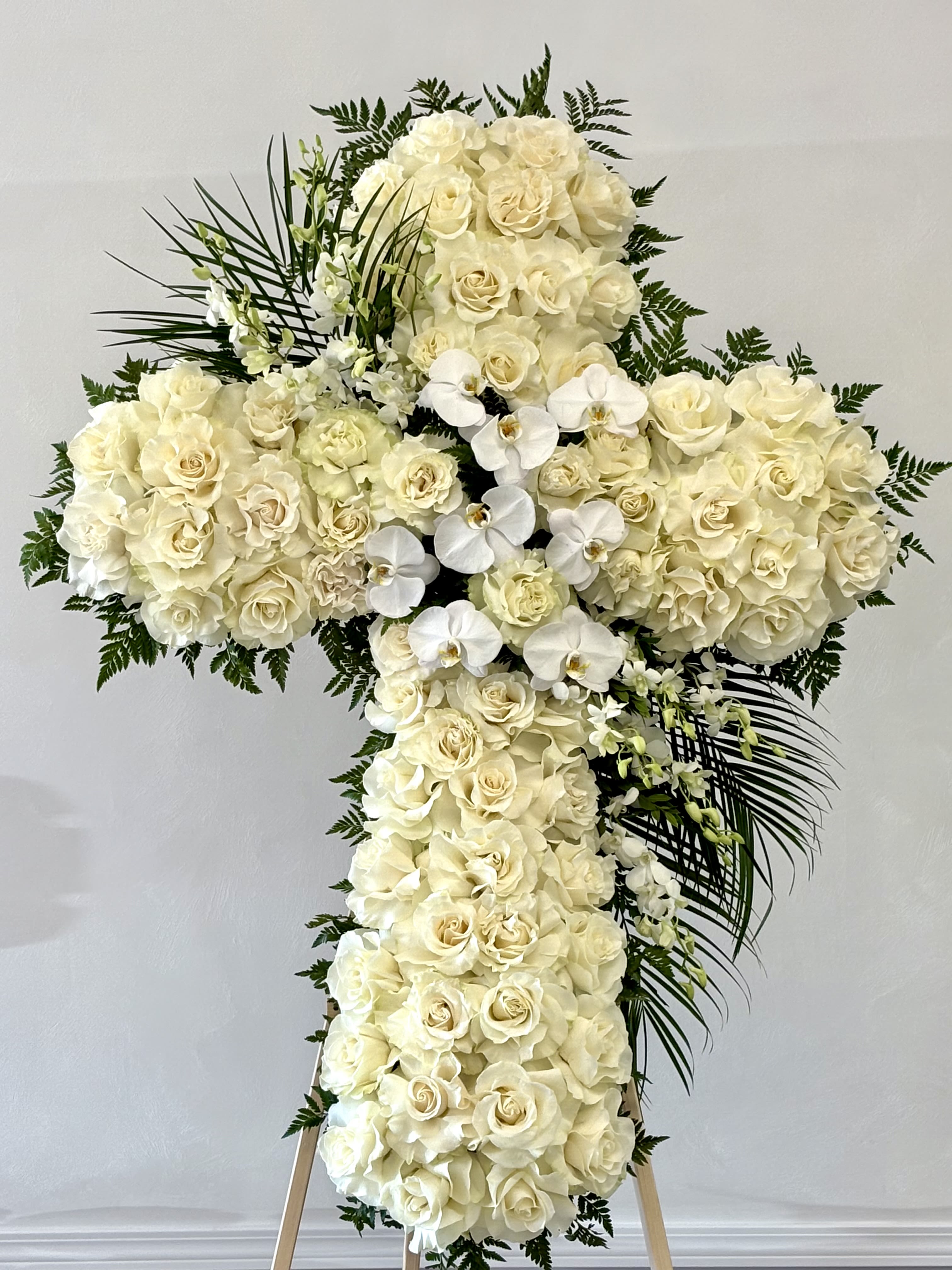Graceful Cross By VLM Flowers Graceful Cross By VLM Flowers - A standing cross made entirely of white roses, symbolizing peace, purity, and eternal love.