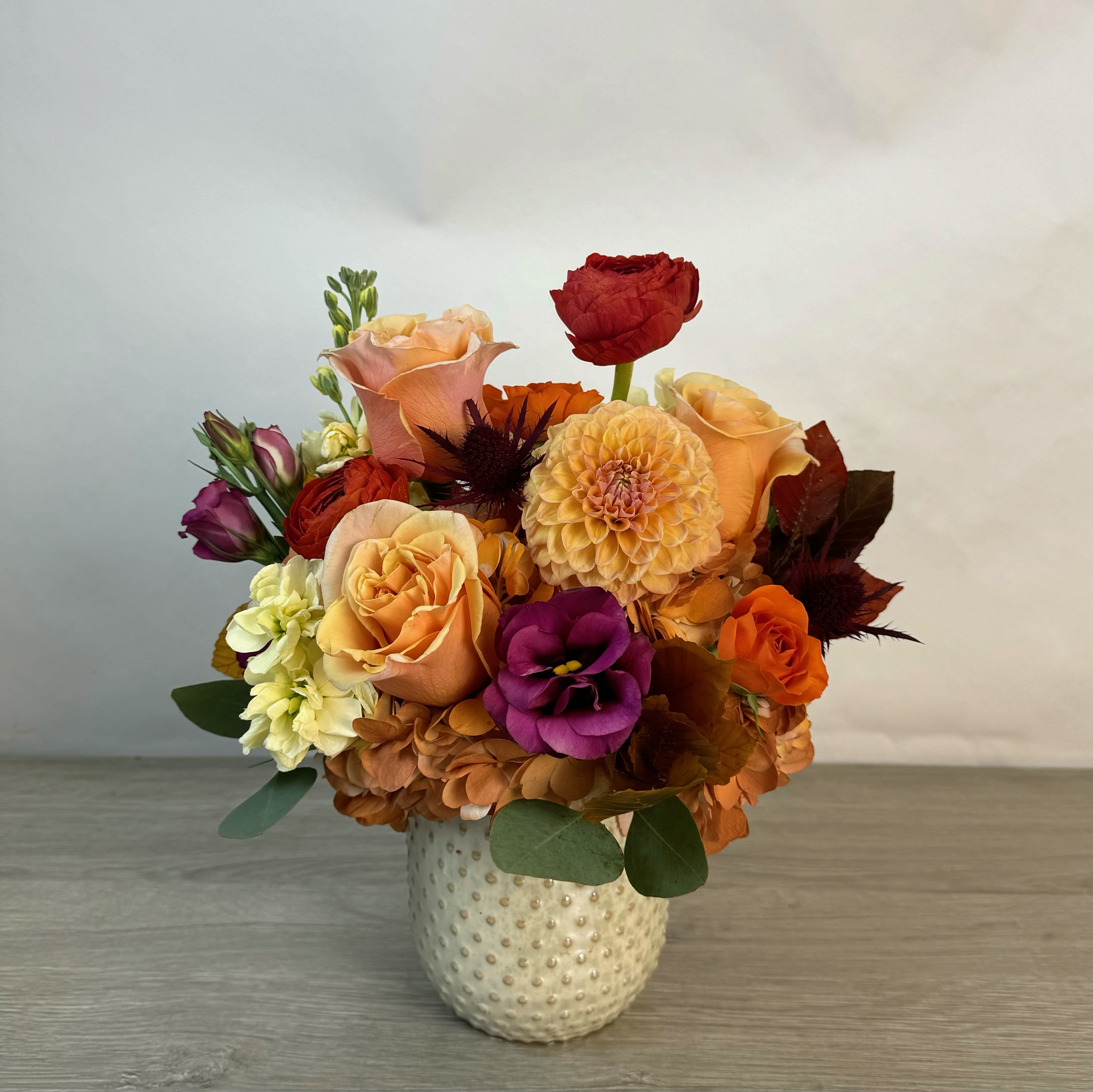 Maple Syrup Maple Syrup - Like the first golden pour of autumn, Maple Syrup is a floral arrangement that captures the richness of the season in full bloom. With shades of amber, burnt orange, honeyed peach and deep berry tones, this bouquet evokes cozy mornings, falling leaves and the comforting sweetness of sweater weather.