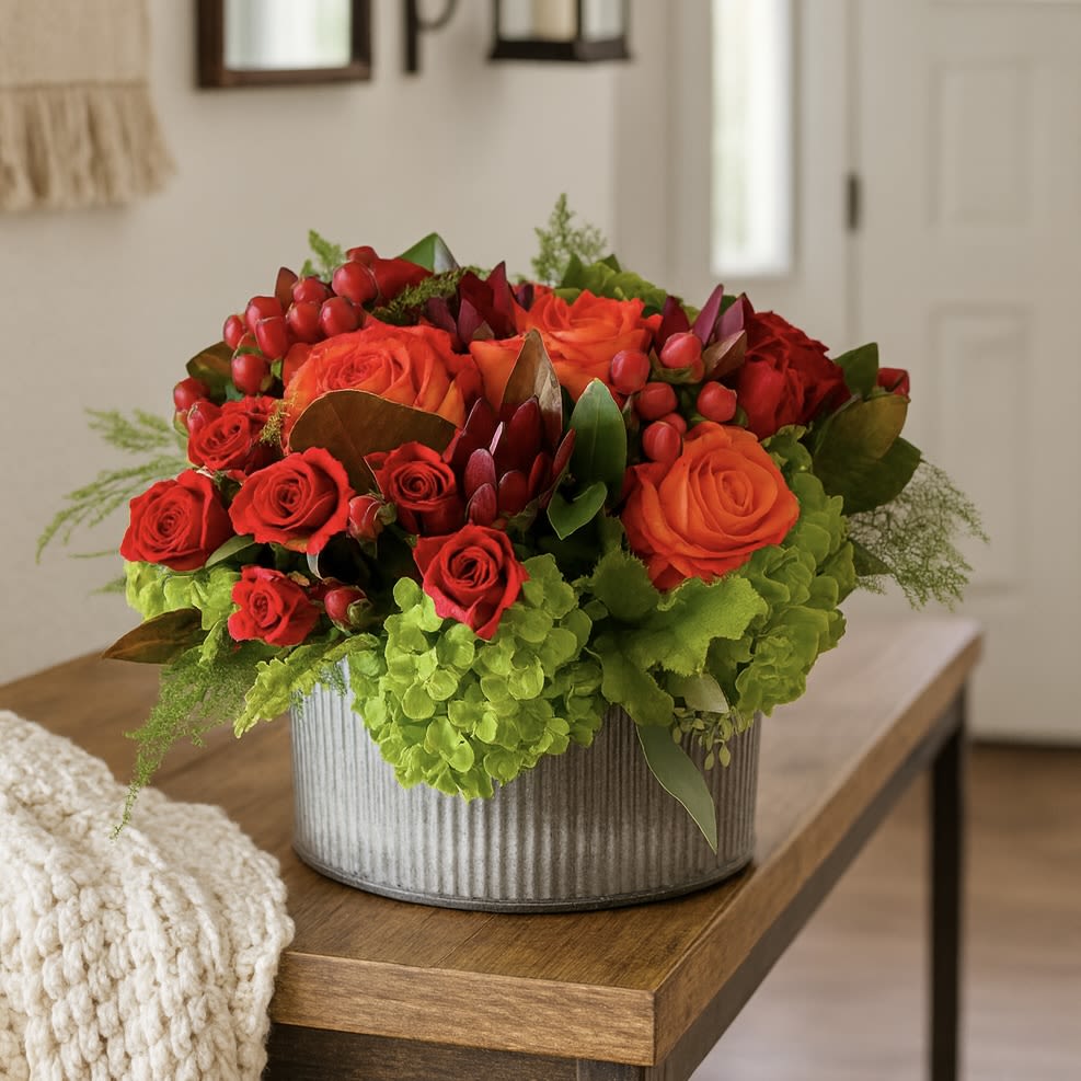Sunset Grove - Seasonal Fall Bouquet  - Sunset Grove – Bold &amp; Cheerful Floral Arrangement  Bring warmth and joy into any space with Sunset Grove, a bold and cheerful floral arrangement designed to brighten every occasion. Presented in the Accent Decor Norah Collection container (7.5 x 4&quot;), this stunning display features lush green hydrangeas, vibrant orange and red roses, charming spray roses, and striking red coffee beans for added texture.  Perfect as a gift or a centerpiece, Sunset Grove captures the beauty of nature’s sunset tones in a modern farmhouse style. Whether you’re celebrating a special moment, sending love, or simply elevating your home décor, this radiant arrangement delivers lasting impressions with its rich autumn-inspired palette.