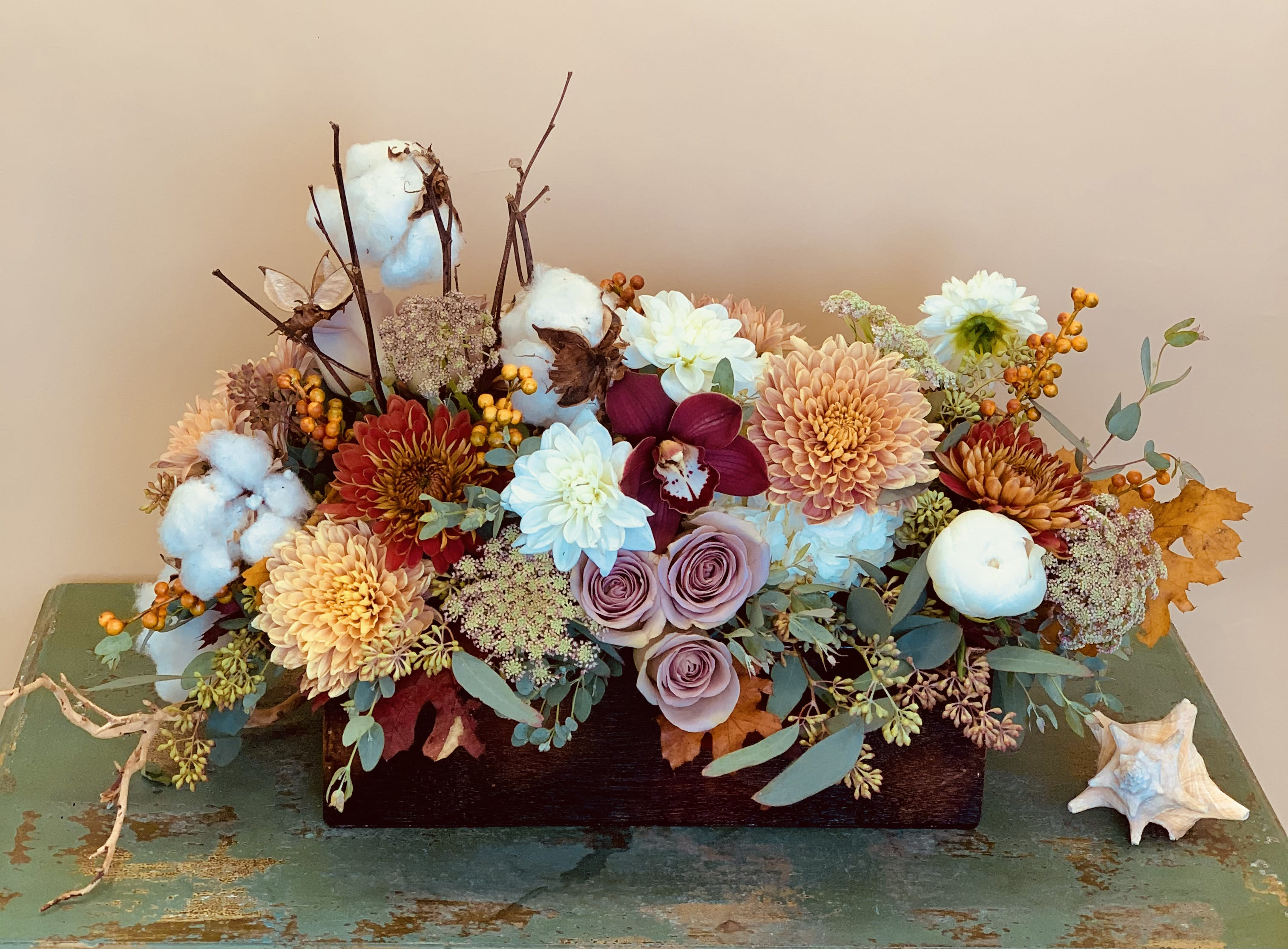 Southern Charm Southern Charm - This stunning new design will warm the heart even in the cold of winter! Showcasing a modern pallet of premium blooms as well as dried elements all artfully displayed in a beautiful wooden box. Can be used as a centerpiece, on your mantle or any space that you’d like to add a touch of beauty! Arrangement can be customized and made in a variety of sizes. Please call for further details. Flowers and container may vary.