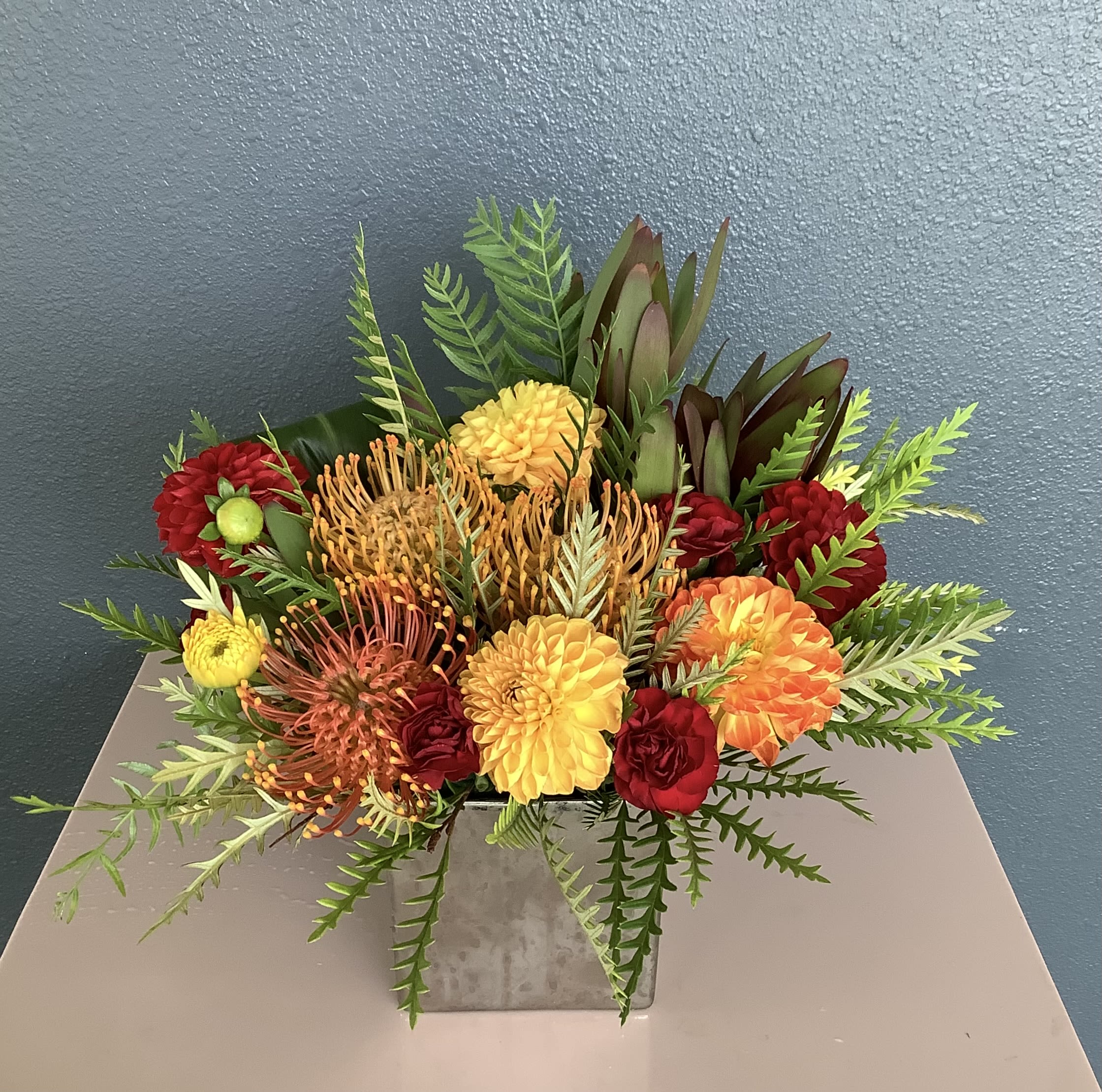 Welcome Home Welcome Home - A lovely, contemporary arrangement of premium autumnal hued dahlias and pincushions. A perfect gift for your thanksgiving host. Flowers may vary, please call if this is a concern.