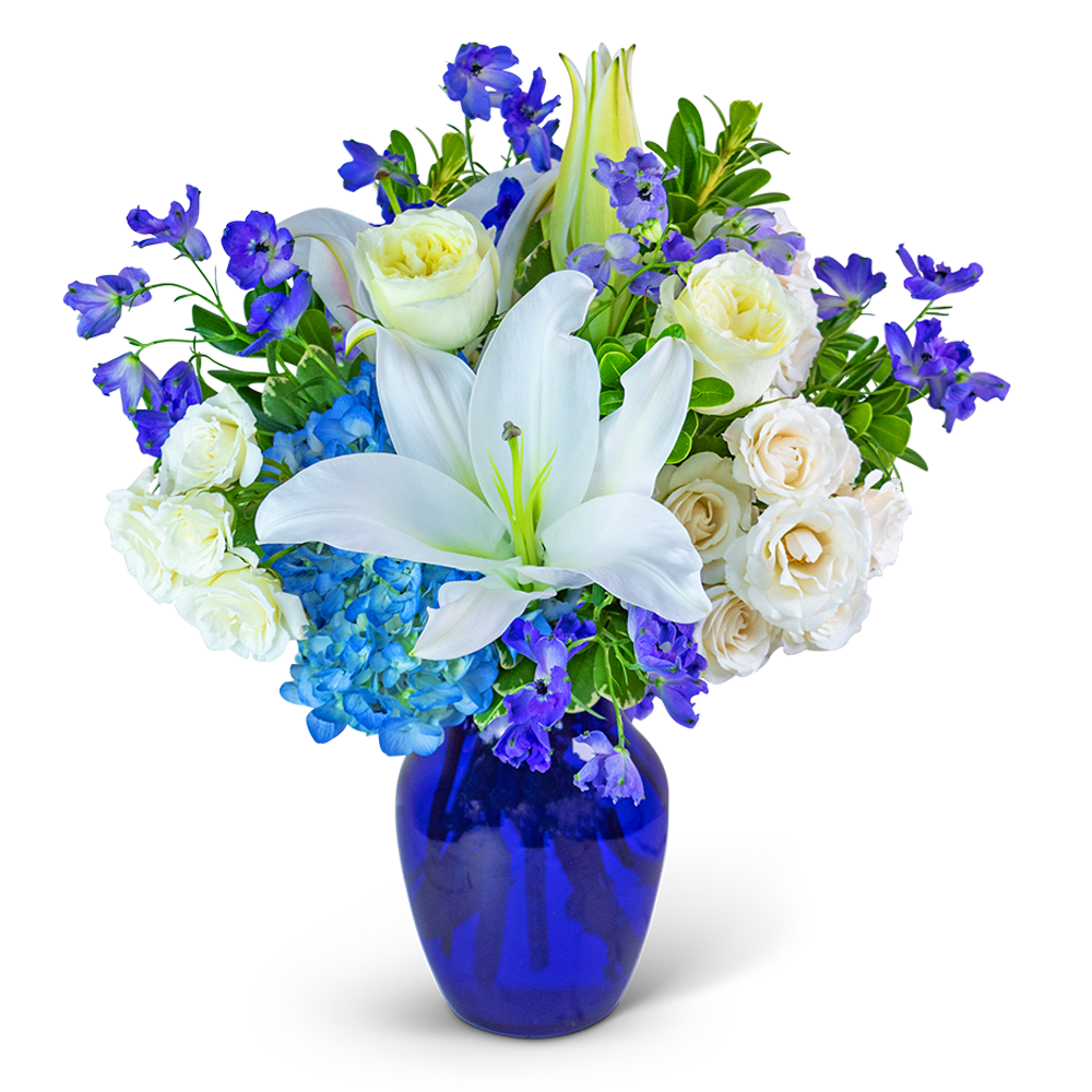Blue Beauty Blue Beauty - Our Blue Beauty flower design is meticulously created with hydrangea, lilies, Delphinium, roses, and an exquisite assortment of premium foliage. This stunning floral arrangement is beautifully presented in a striking blue glass vase, radiating a sense of tranquility and elegance. Transform any space into a haven of serenity with the enchanting Blue Beauty, a true testament to the captivating beauty of nature.