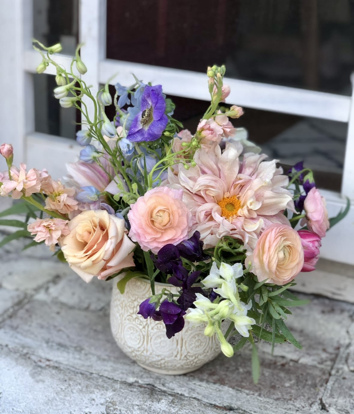 LUCY - A super pretty design with gorgeous soft pink dahlias, Hermosa roses, accents of light purple sweet peas. Nestled in a very pretty 6x5 ceramic container. 