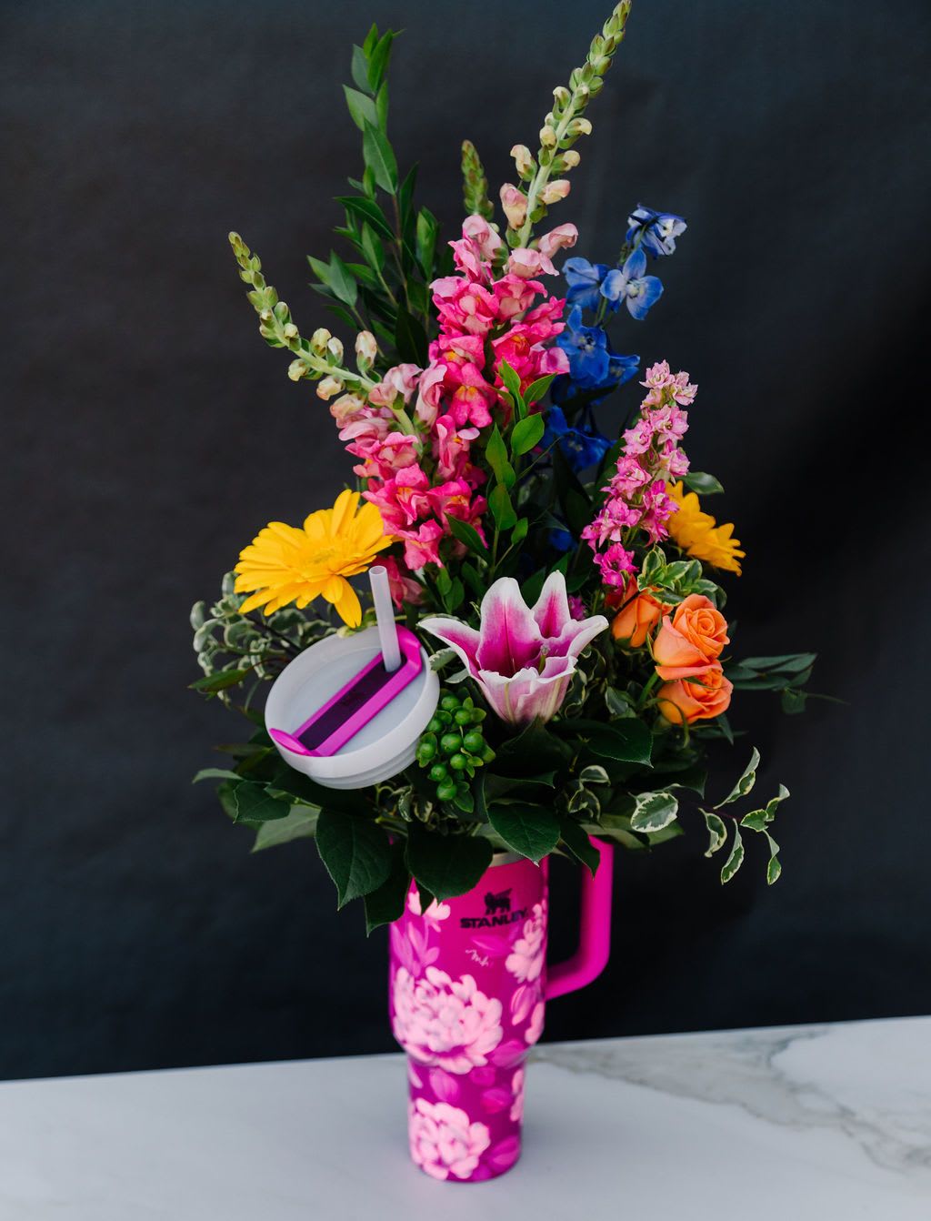 Peony Pop SALE! 40%off Peony Pop SALE! 40%off - Bold, bright, and unapologetically fabulous—the Peony Pop Stanley is a floral power move. Coated in a vivid magenta and covered with lush hand-painted peonies, this tumbler doesn’t whisper cute—it shouts it. With a heavy-duty build, dishwasher-safe finish, and serious style cred, it’s your go-to for keeping drinks hot, cold, and always cool. One of a kind and wildly unforgettable—just like you. ***Flowers may vary from photo above*** Order Now! Each tumbler is a one-of-a-kind, hand-painted piece sealed with a clear gloss powder coat—dishwasher safe, chip-resistant, and made to last; by artist Melanie Haggard @meligrafi. Want the tumbler without flowers? Just click the “Gift” tab at the top of the page.