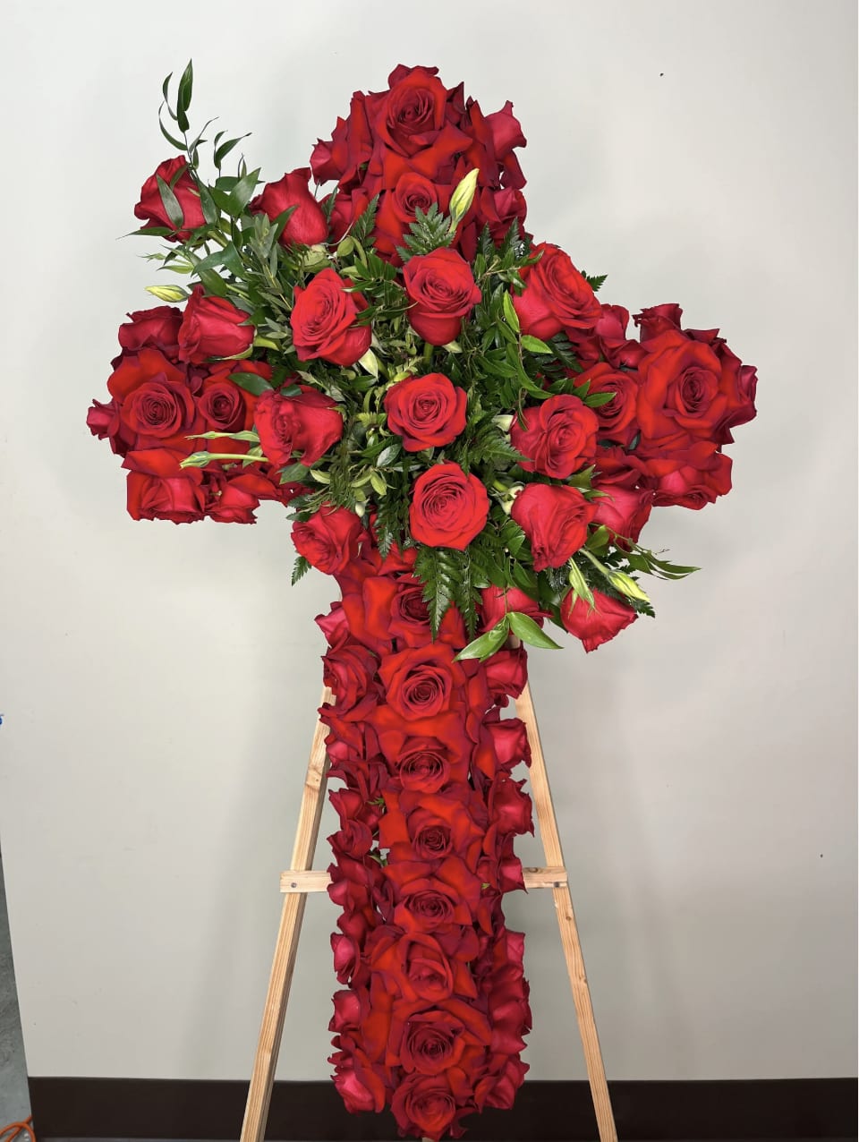 Heartfelt Roses Cross - This timeless funeral cross is crafted entirely with fresh roses, symbolizing love, respect, and eternal remembrance. A graceful and heartfelt tribute to honor the memory of a loved one.  