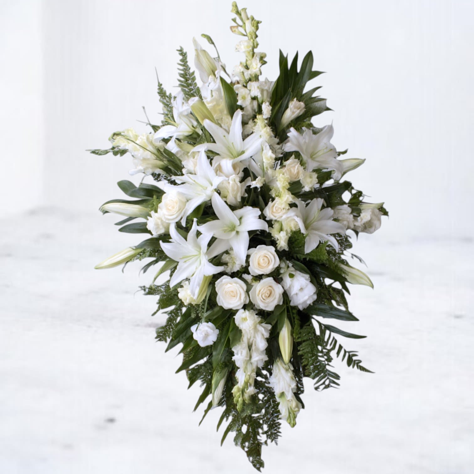 Eternal Grace Standing Funeral Spray Eternal Grace Standing Funeral Spray - Honor a life beautifully lived with our Eternal Grace Standing Spray. This elegant display features pure white lilies, roses, and snapdragons arranged with lush greenery in a cascading design. A timeless tribute of peace and remembrance, it brings comfort and serenity to funeral and memorial services. Available for same-day sympathy flower delivery in Magnolia, The Woodlands, Spring, and Montgomery, TX.