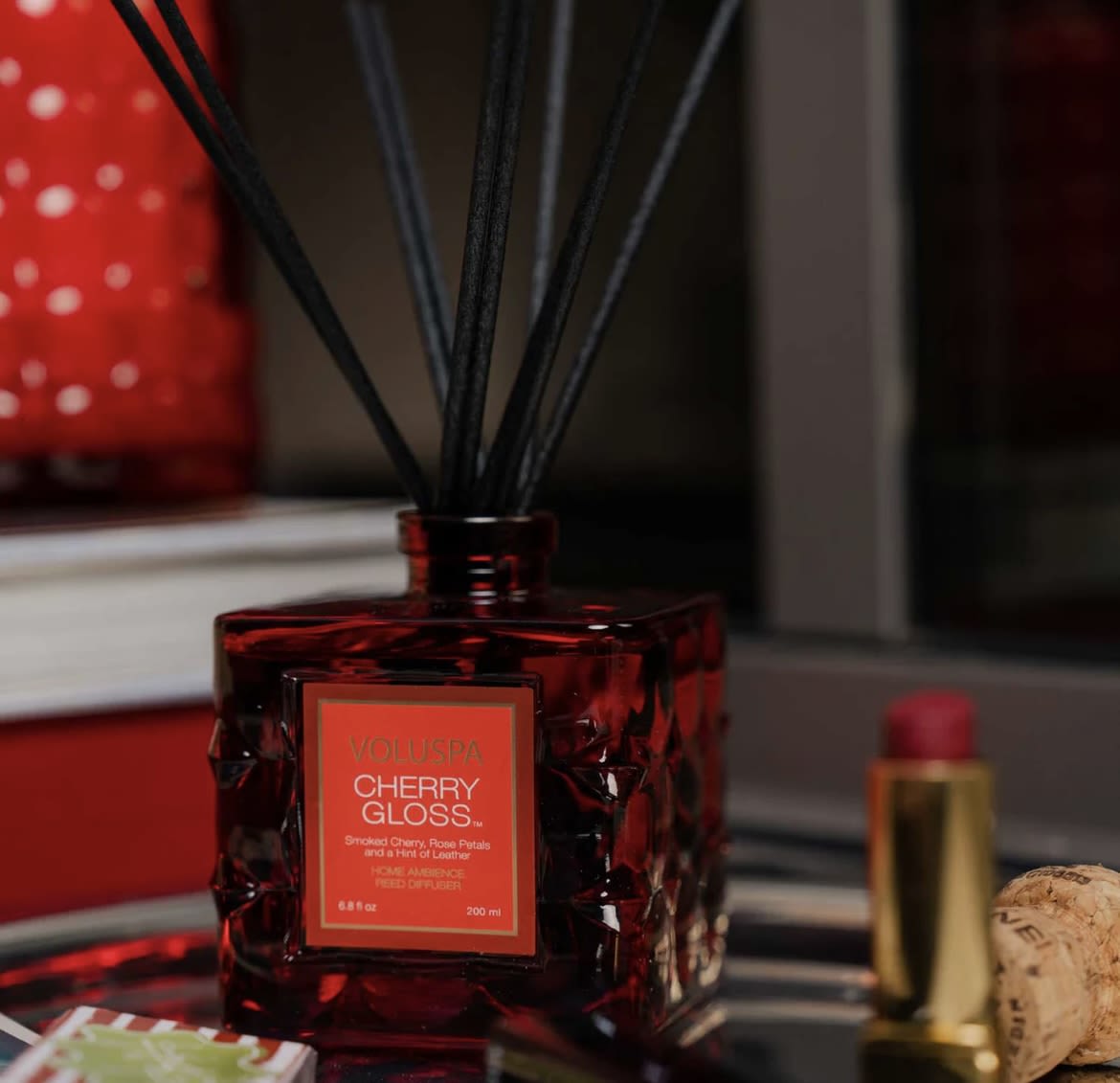 CHERRY GLOSS REED DIFFUSER - Embrace the power of seduction with Cherry Gloss. Smoked Cherry meets love me, love me not Rose Petals, combined with the confidence of Guaiac Wood and a hint of Leather. Strut the aromatic catwalk of dynamic Cherry Gloss.